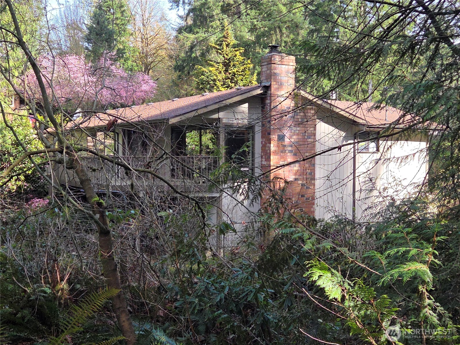 House view from the 2nd driveway. There is a stand up crawl space with access under the deck