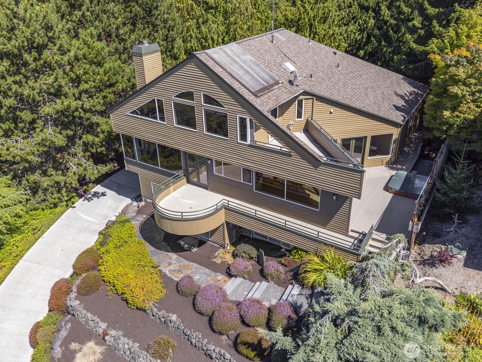 Exquisite example of a NW Contemporary home design. High ceilings, big view windows and outdoor space. Note the very private setting.