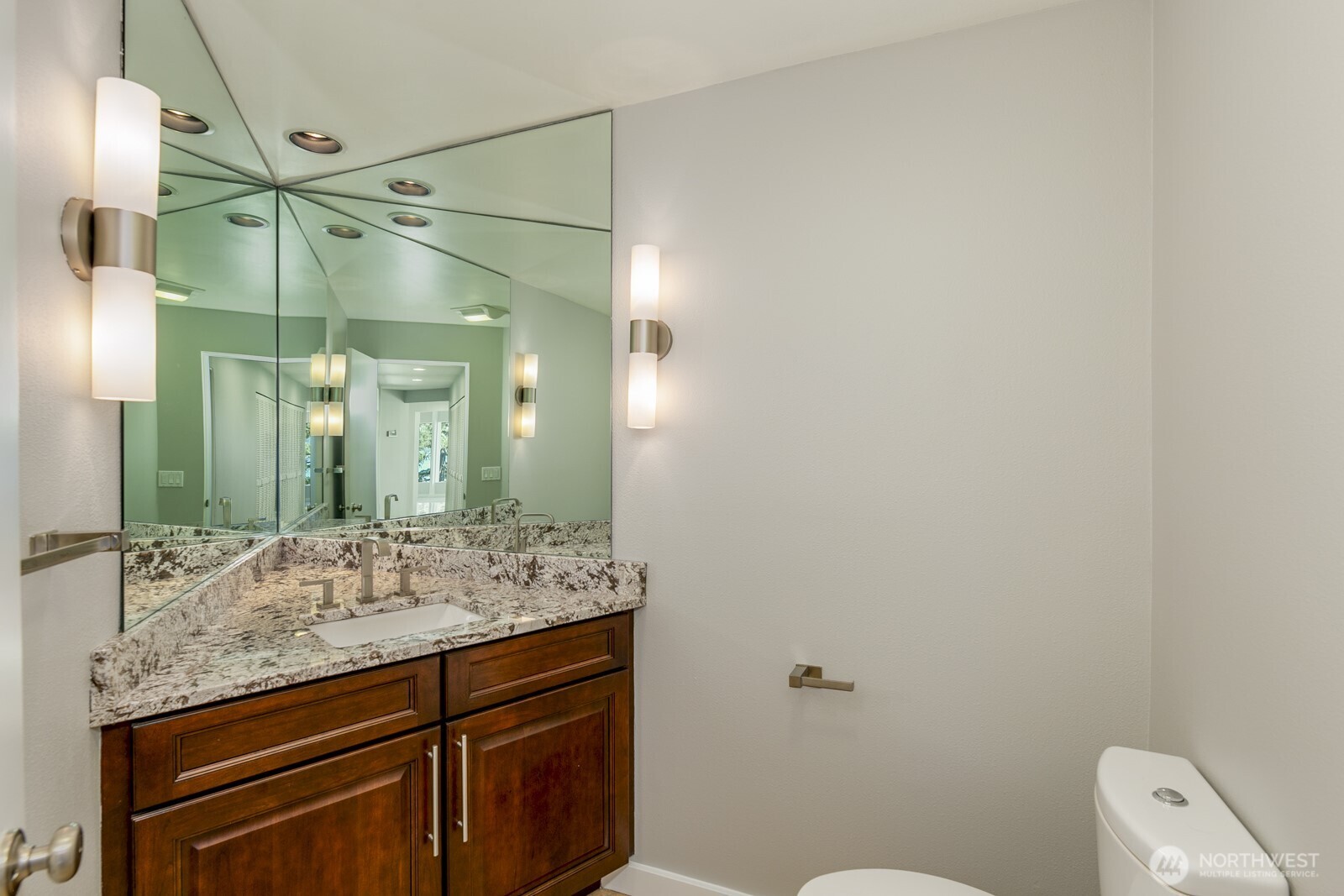 The main floor powder room has an infinity mirror.