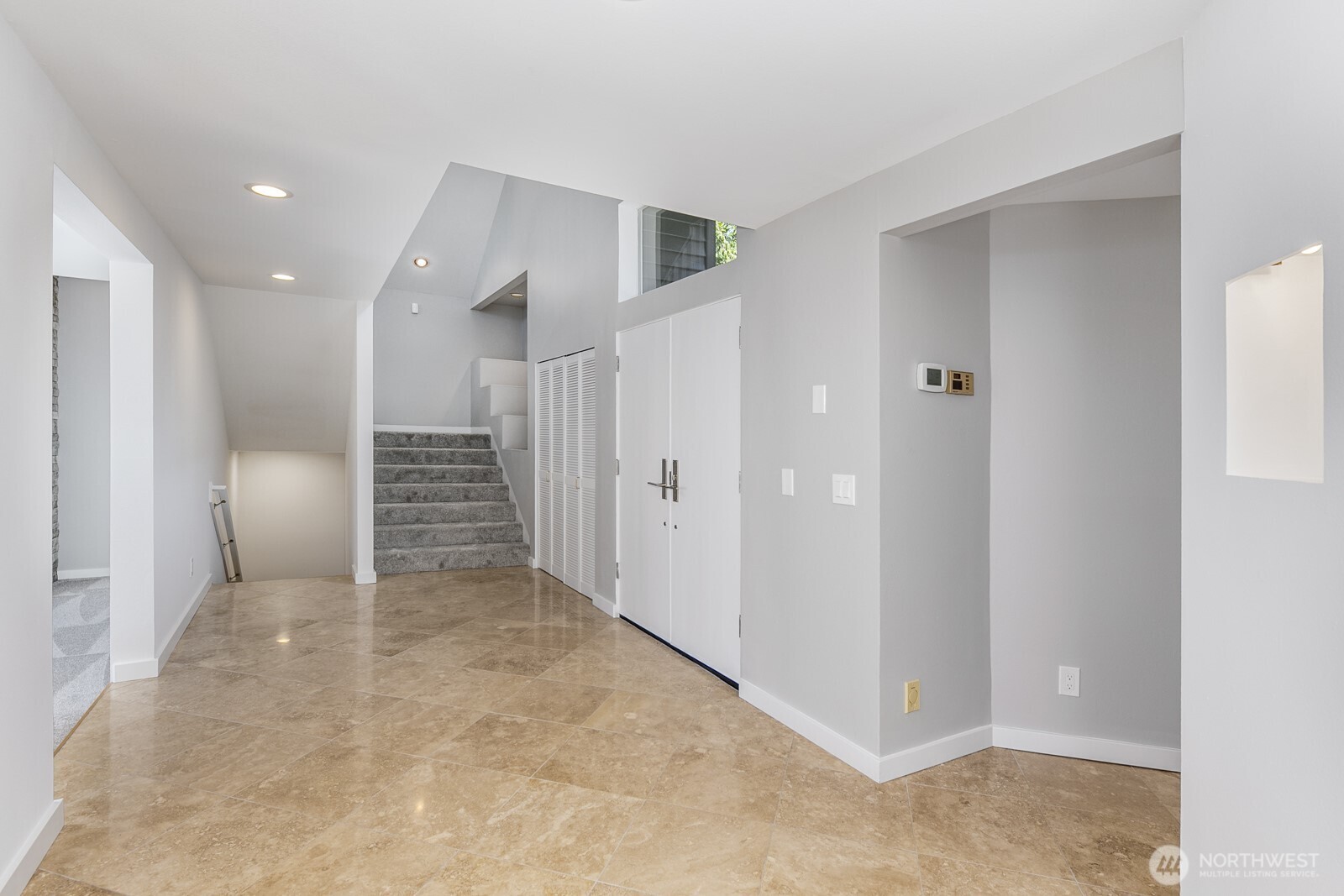 Looking back through the entry at the stairs to the seond and lower levels.
