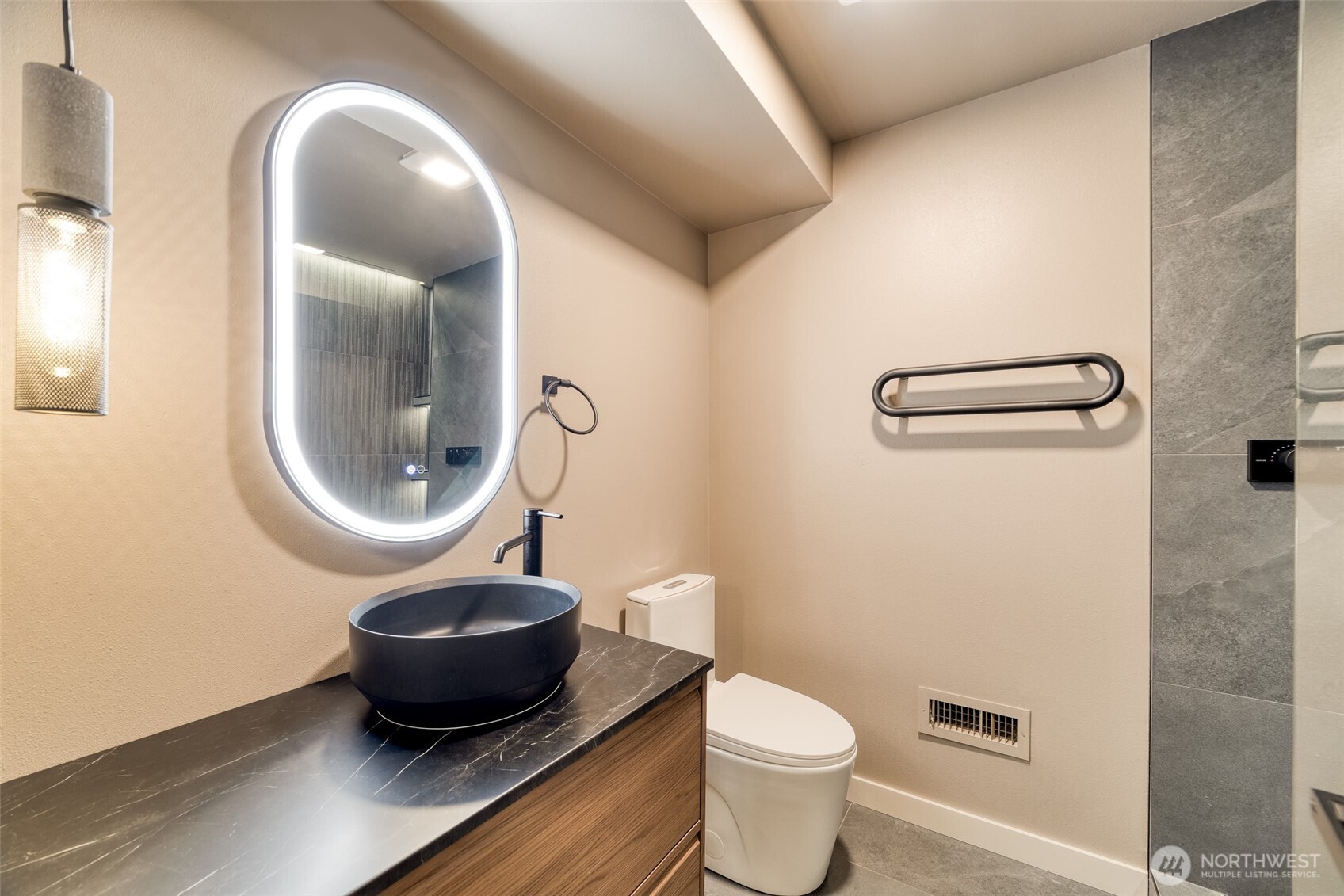Downstairs guest bathroom with serene walk-in shower.