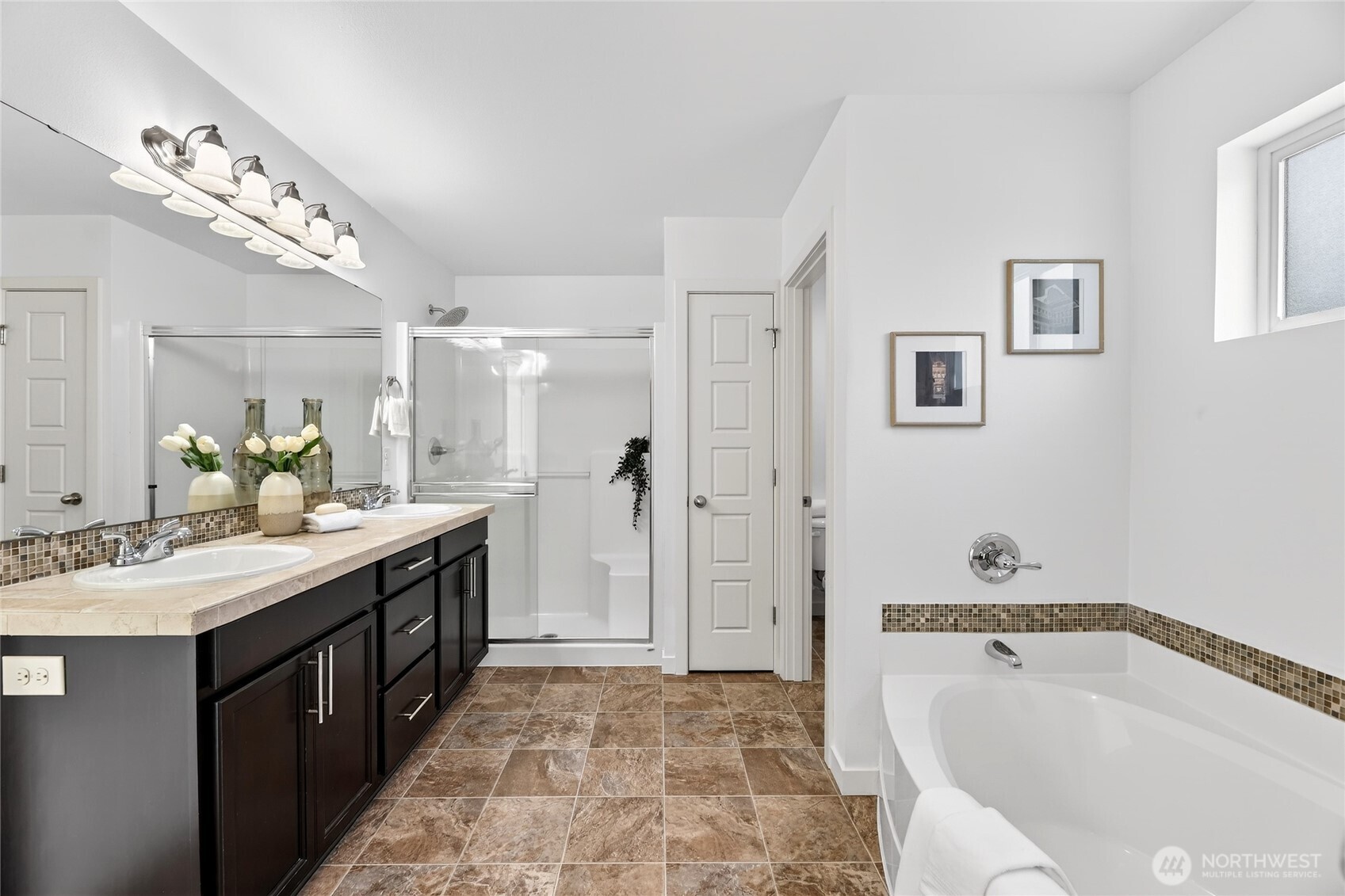 Ensuite Bathroom off Primary features a seperate soaking tub, stand up shower, double vanity and throne room.