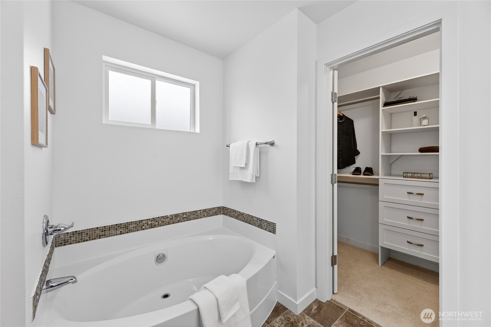 Walk-In-Closet is just off the Primary's Ensuite Bathroom featuring a seperate soaking tub.