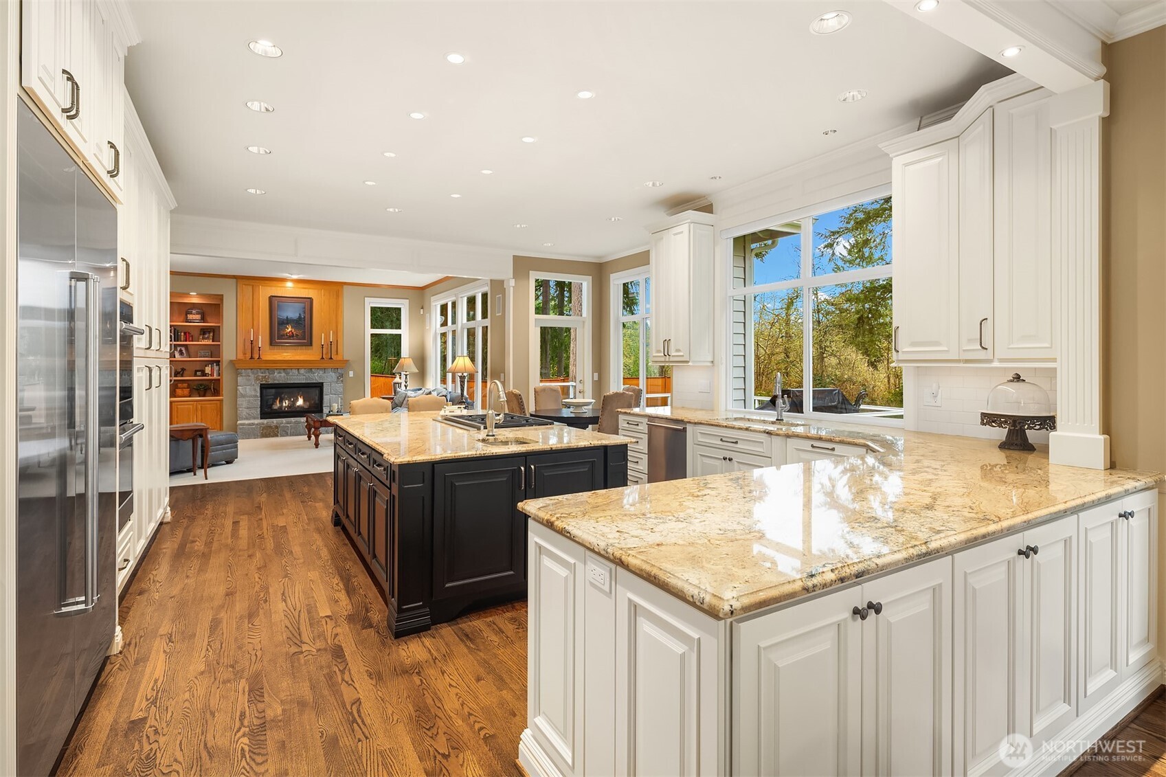 Gorgeous, spotless, expanded and remodeled Chef's kitchen ~ granite counters, huge island, eating bar, 6-burner Wolfe range, double ovens, SubZero fridge and abundant cabinet & counter space.