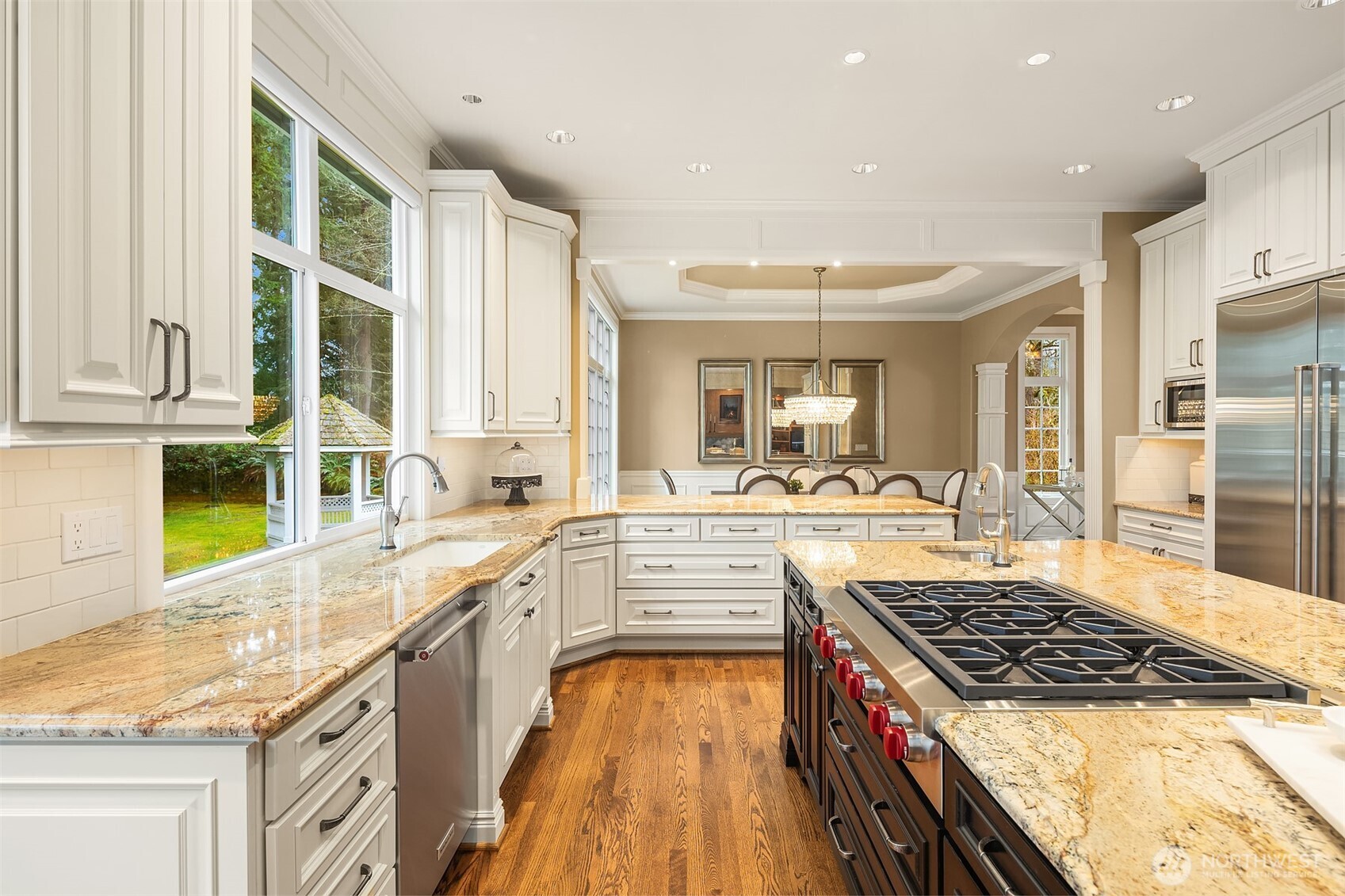 Gorgeous, spotless, expanded and remodeled Chef's kitchen ~ granite counters, huge island, eating bar, 6-burner Wolfe range, double ovens, SubZero fridge and abundant cabinet & counter space.