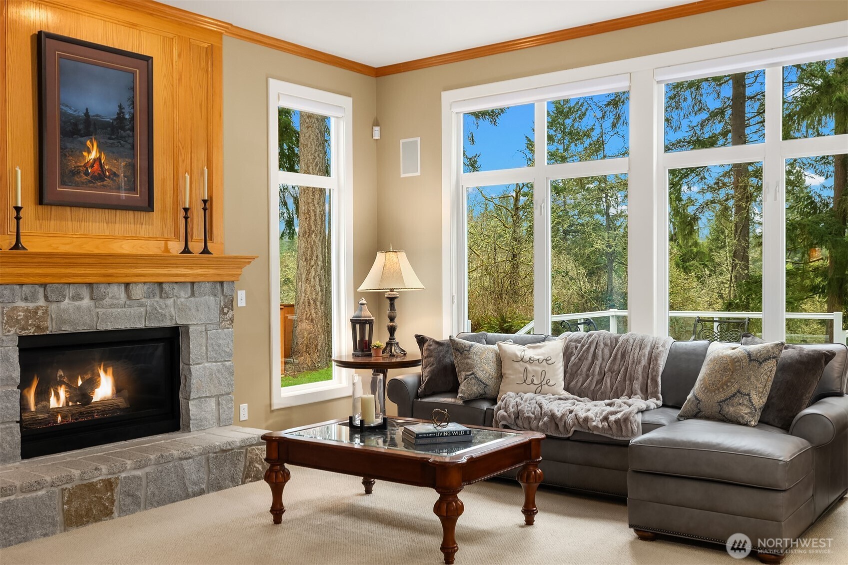Family room with stone fireplace and built-in shelving. Private, wooded outlooks from nearly every room in the home.