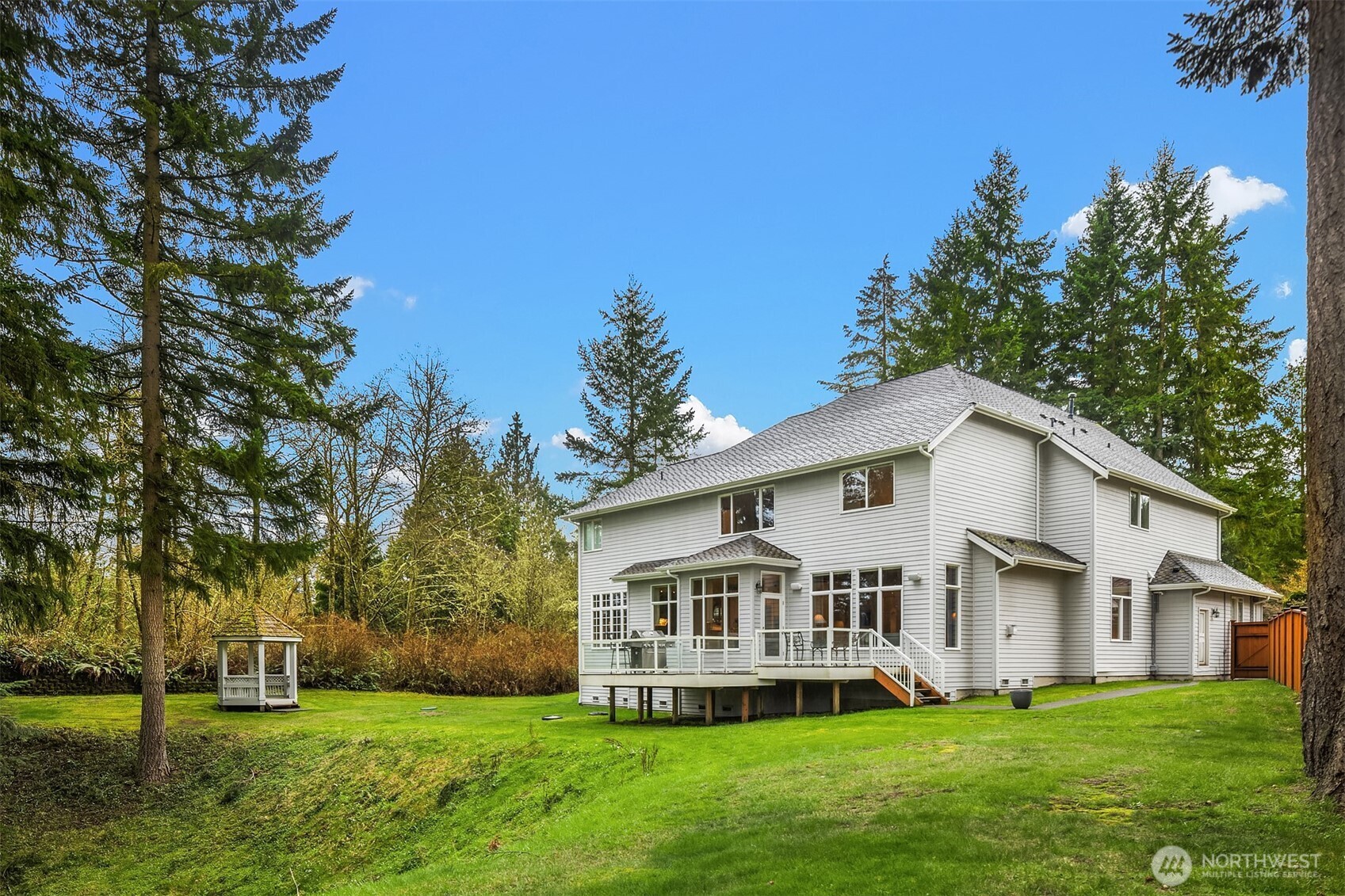 The back yard offers the home with its own outdoor/yard space, and the native growth provides a privacy buffer to the community park.