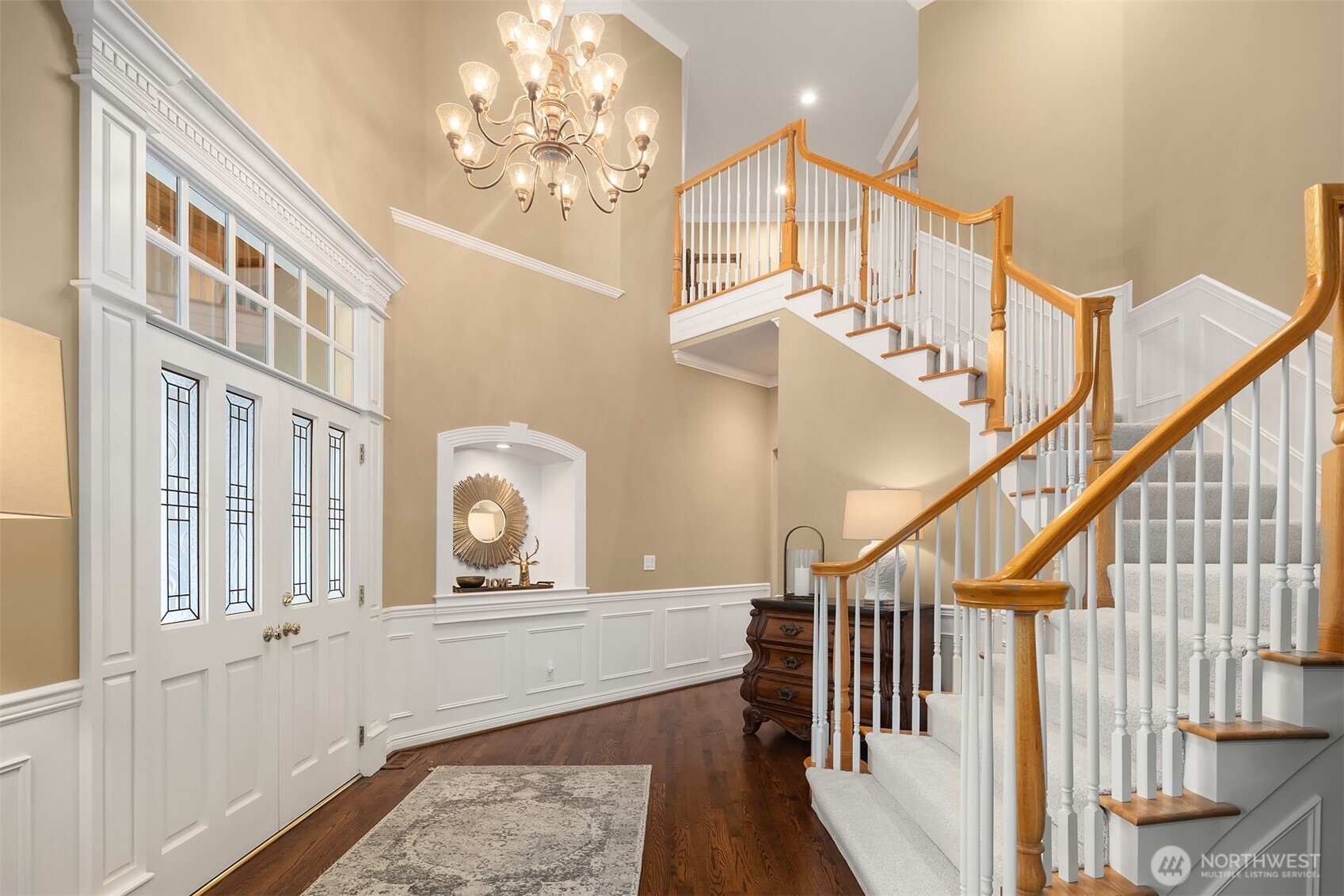 Enter to a grand, light-filled foyer that reveals a signature statement in craftsmanship of this lauded, premier Northwest Builder ~ beautifully detailed crown moldings, coffered ceilings, chair rail, wrapped windows, extensive built-ins and quality trim finishes providing warmth and sophistication.