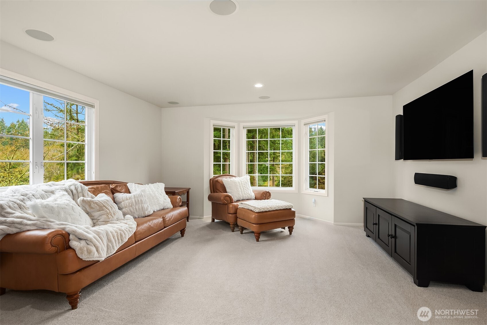 A spacious upper-level bonus room is complete with built-in surround-sound speakers, and provides more private outlooks to the back yard.