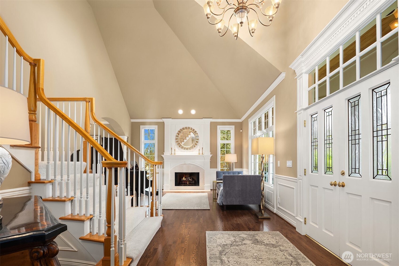 Enter to a grand, light-filled foyer that reveals a signature statement in craftsmanship of this lauded, premier Northwest Builder ~ beautifully detailed crown moldings, coffered ceilings, chair rail, wrapped windows, extensive built-ins and quality trim finishes providing warmth and sophistication.