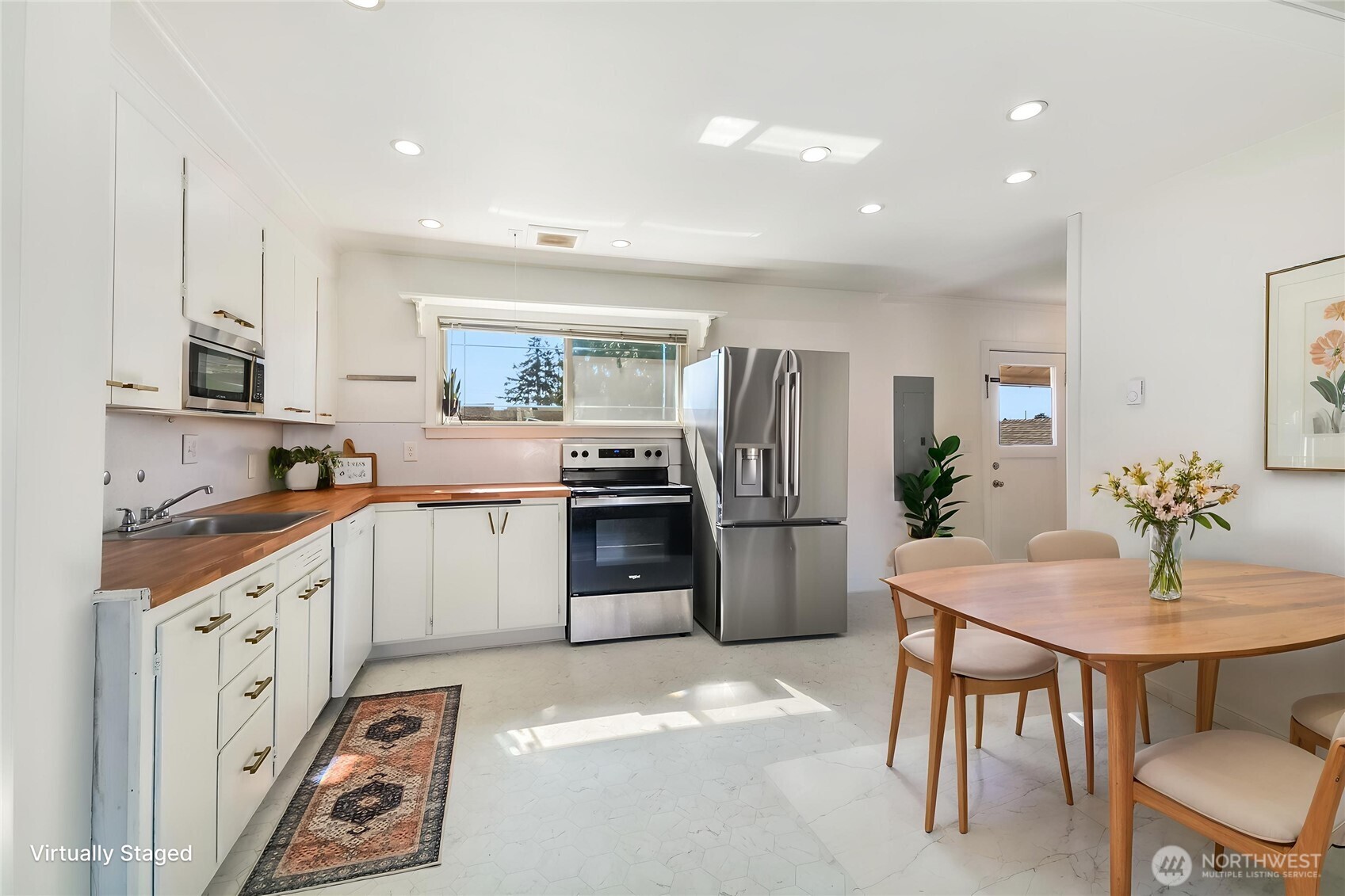 Light and bright kitchen with window overlooking the backyard.