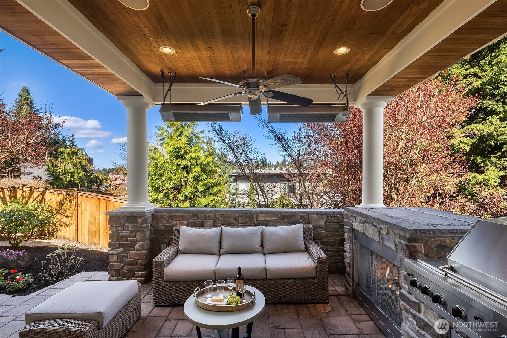 French doors open to a private covered patio with a fireplace and built-in BBQ — perfect for relaxed nights in or easy entertaining.