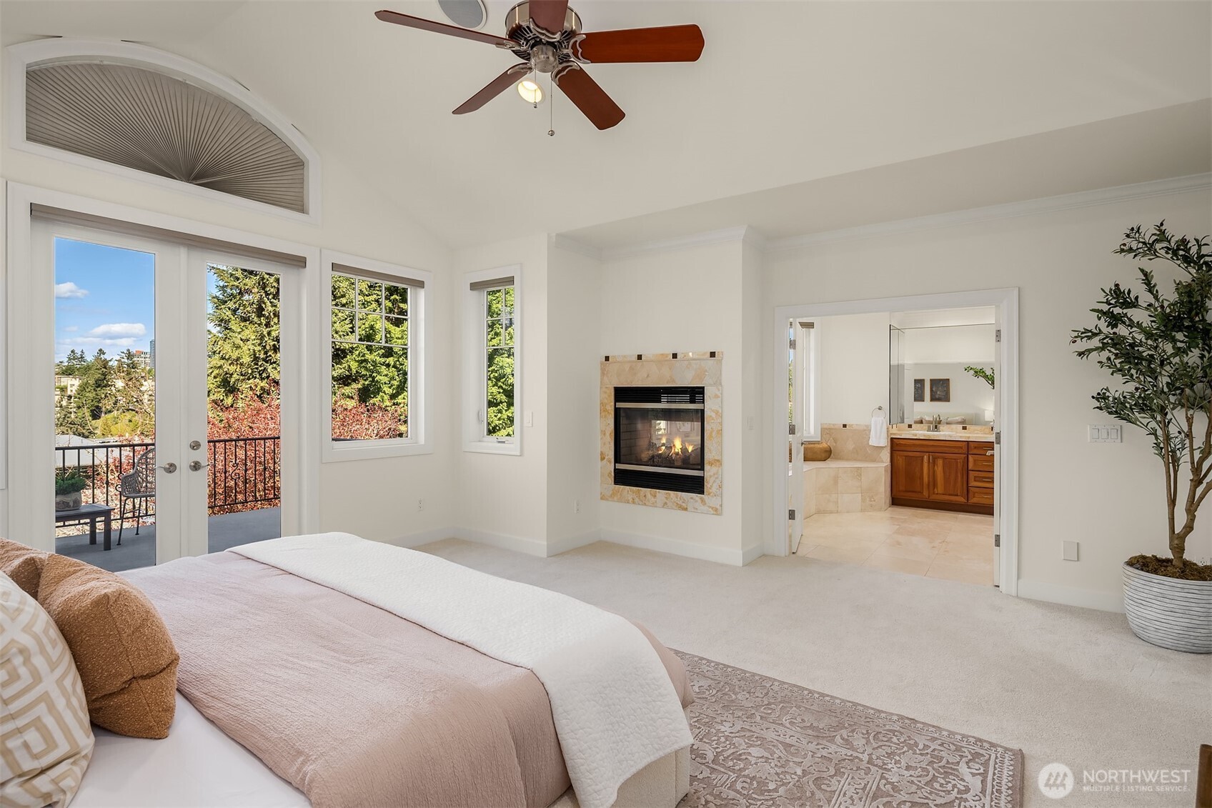 The primary suite is completed with a cozy fireplace, walk-in closet, spa-style bath, and private deck.