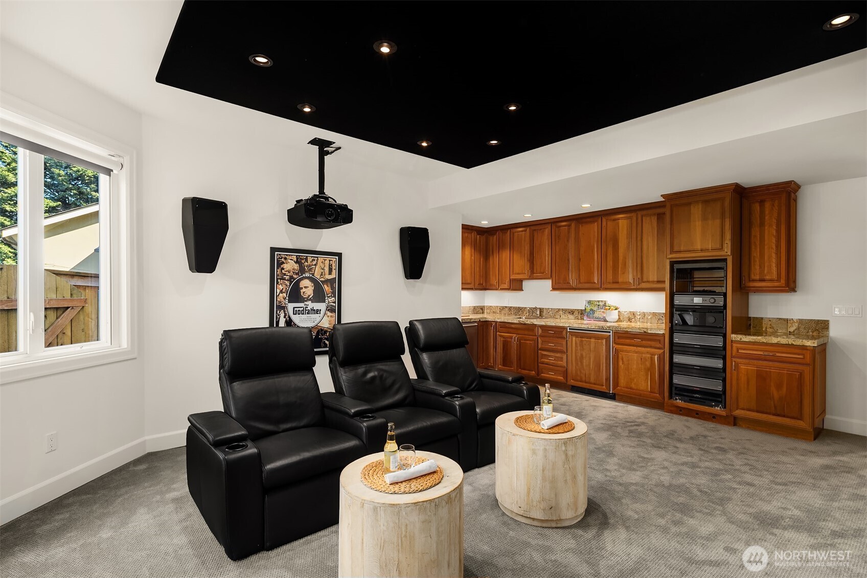 Lower level entertainment area complete with a kitchenette with a dishwasher and refrigerator.