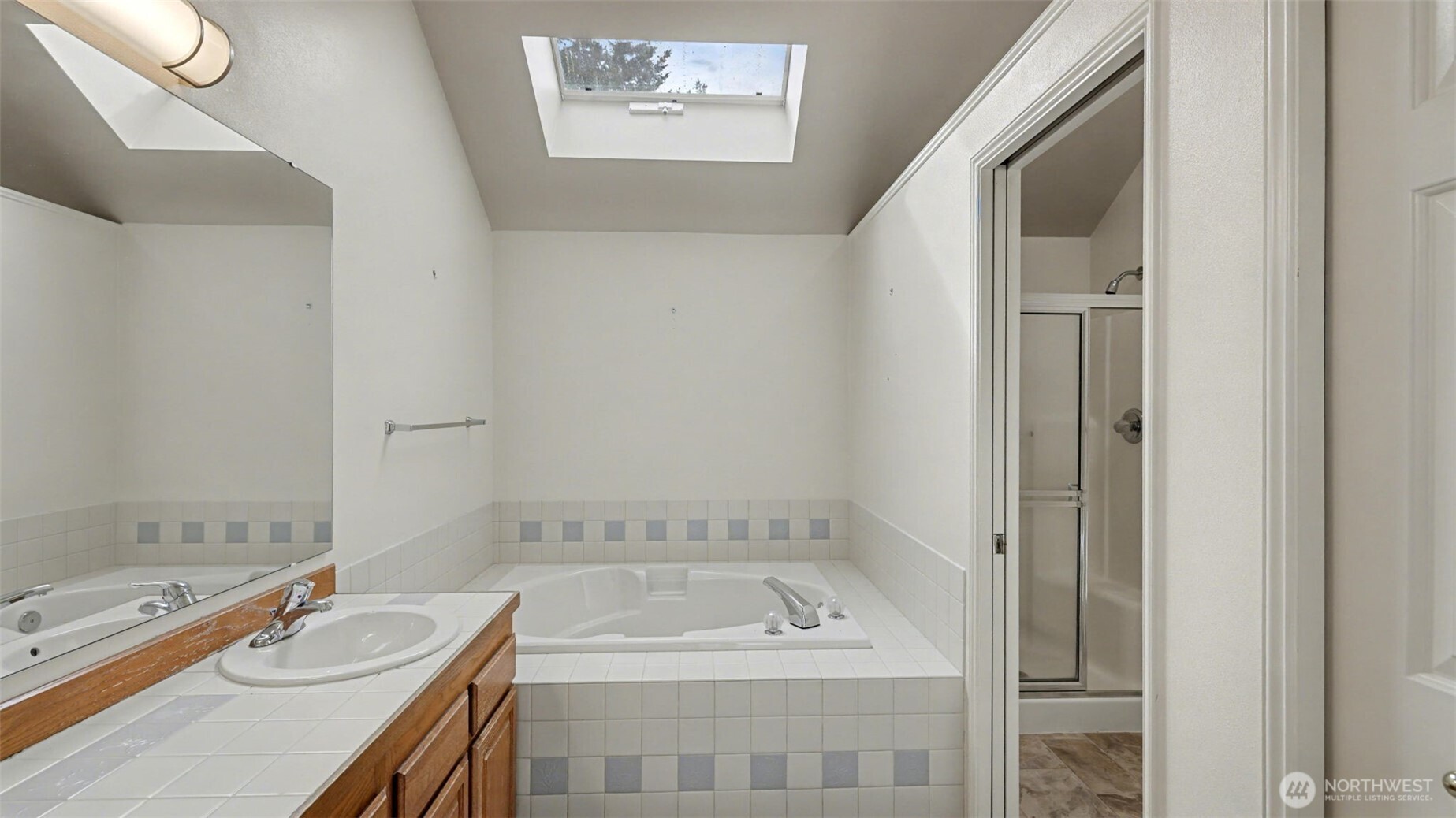 5 piece primary bathroom with tons of natural light