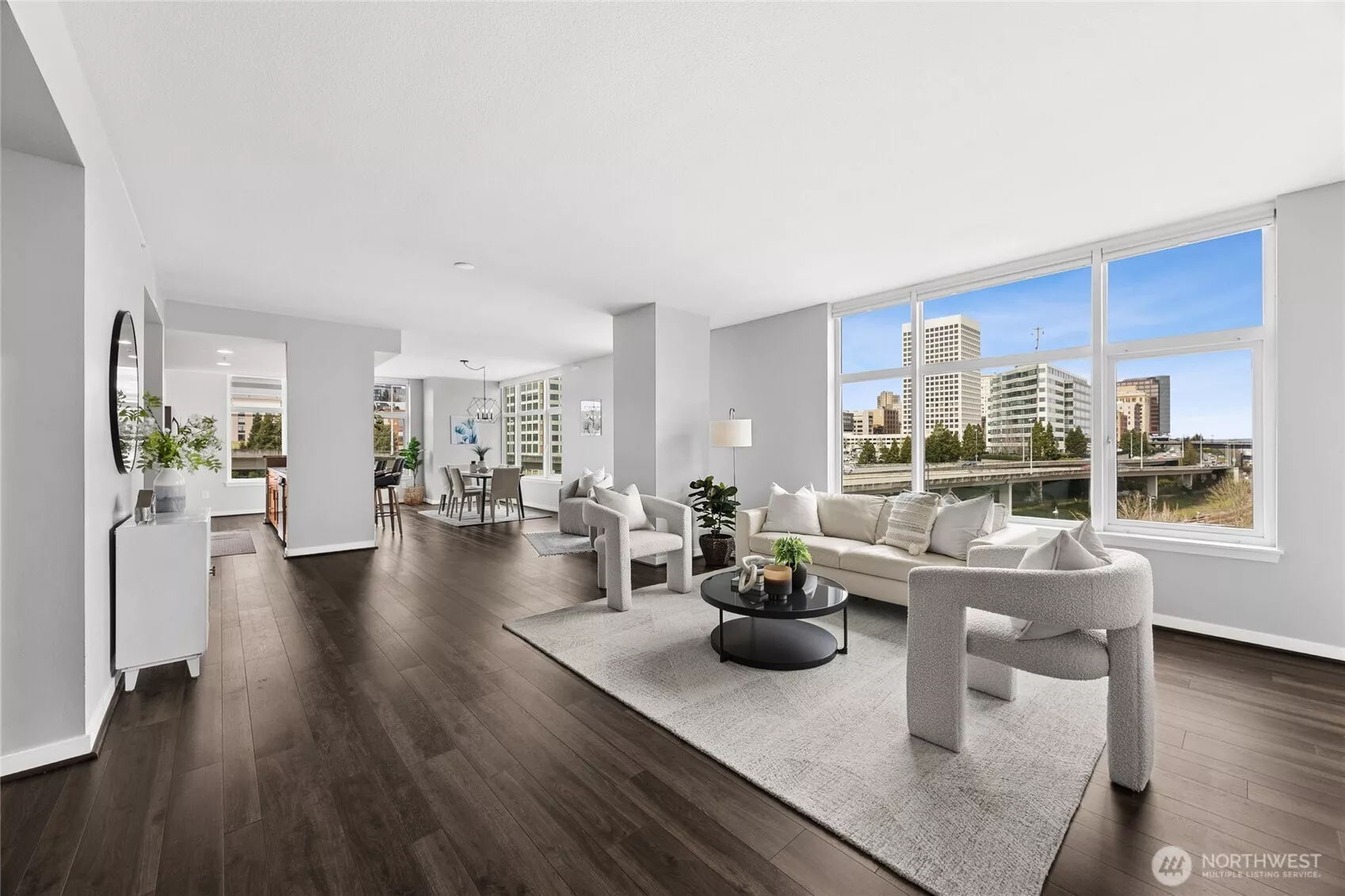 Your living room is anchored by an expansive window that frames gorgeous city views.