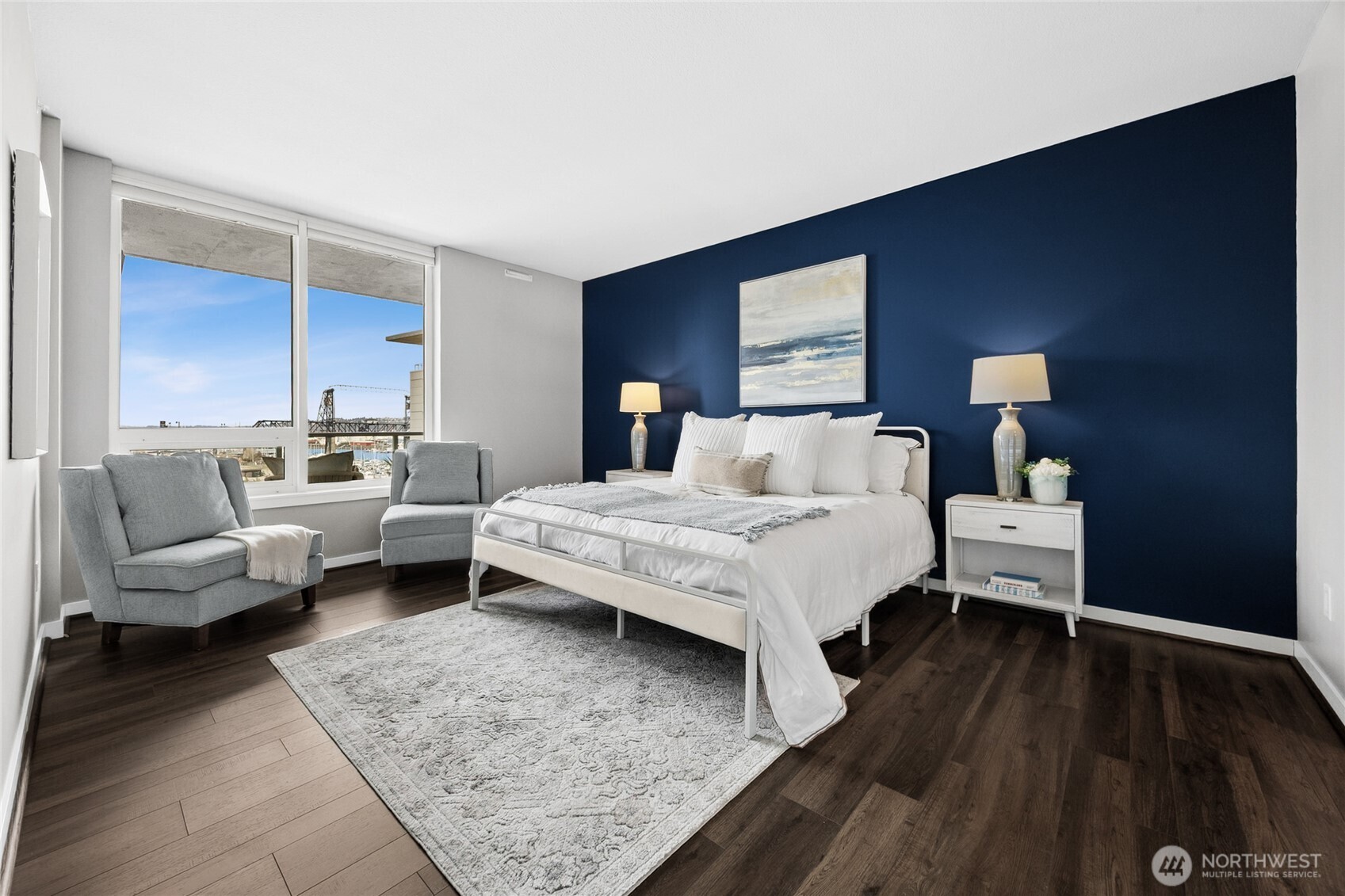 The primary suite is an oasis of calm and beauty, shown here with a king-size bed.