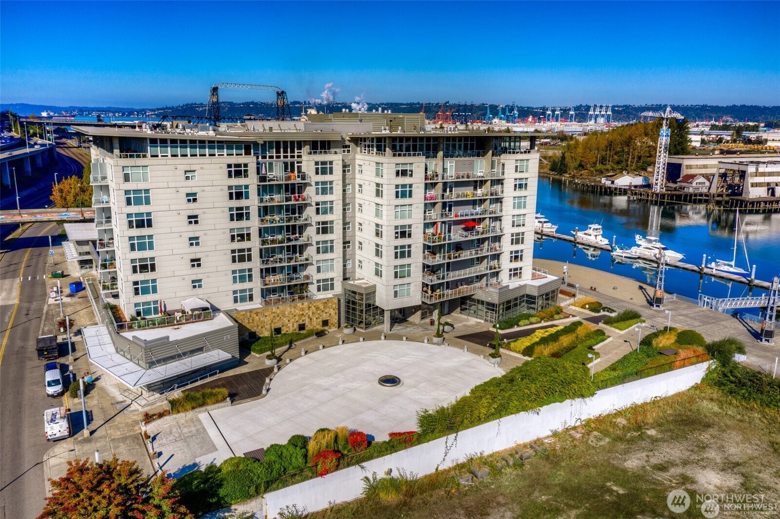 Here is an aerial view of the Esplanade showing the traffic circle convenient for quick stops. The parking garage entrance is along Dock Street to the left side. Suite 704 includes three assigned parking spaces!