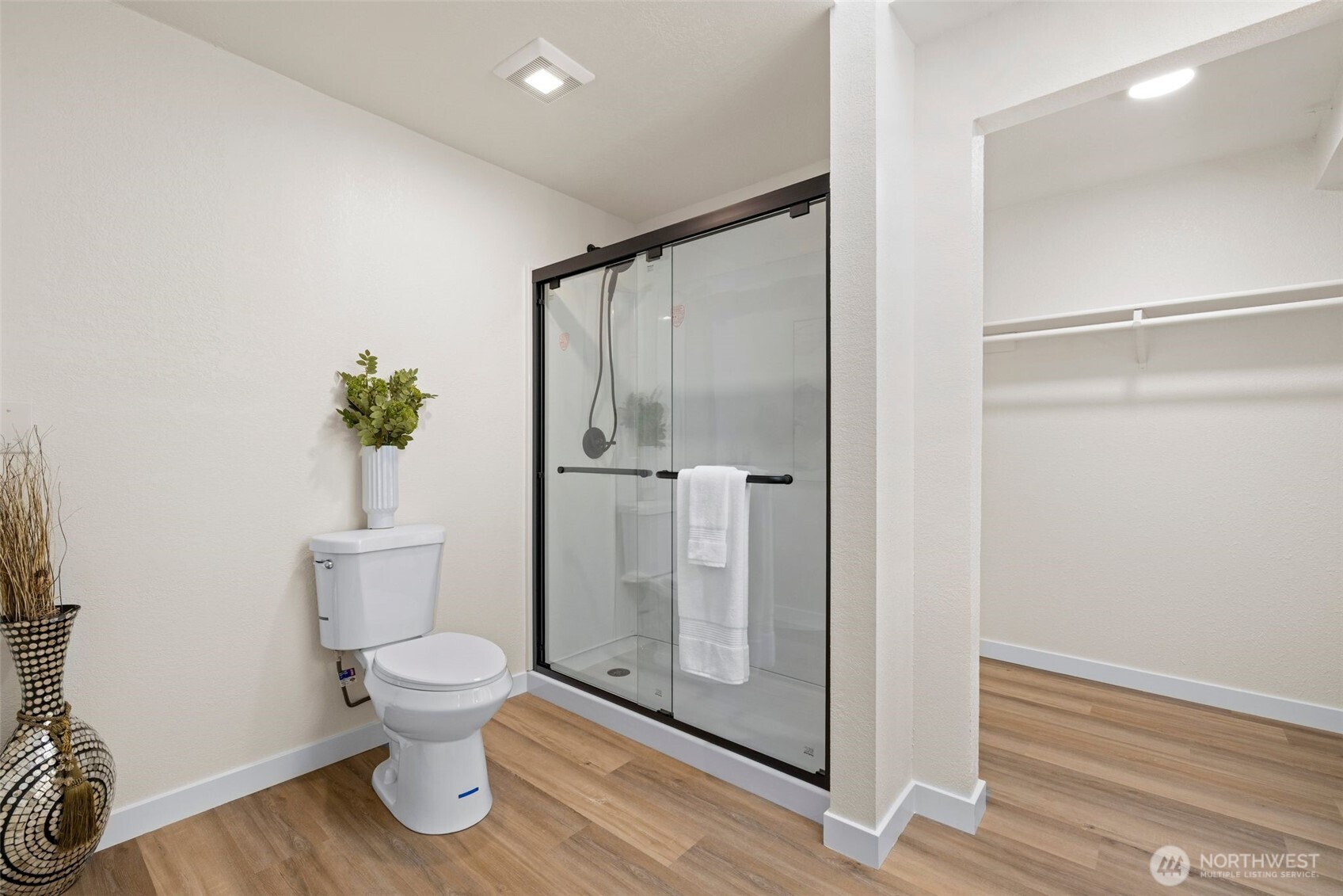 Freshly updated primary bath with a walk-in closet