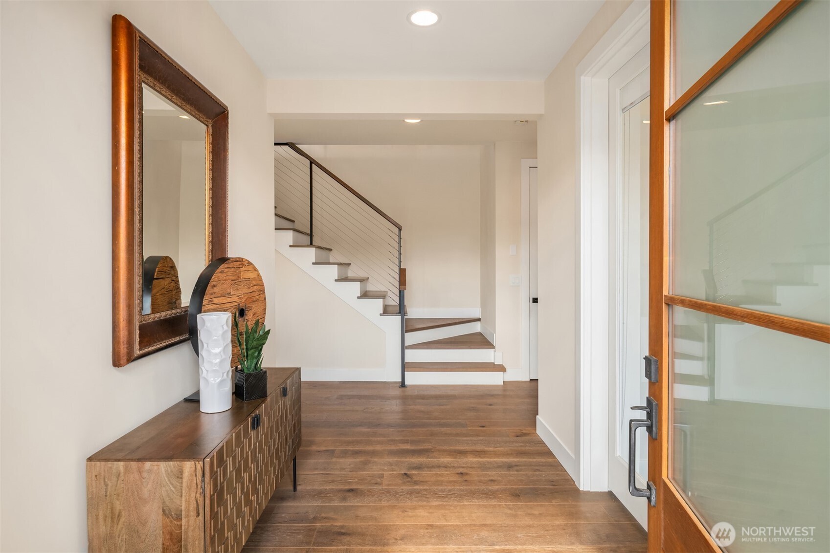 This aerial shows home with rooftop lake-view deck over garage, alley access to 2-car garage, and lawns.