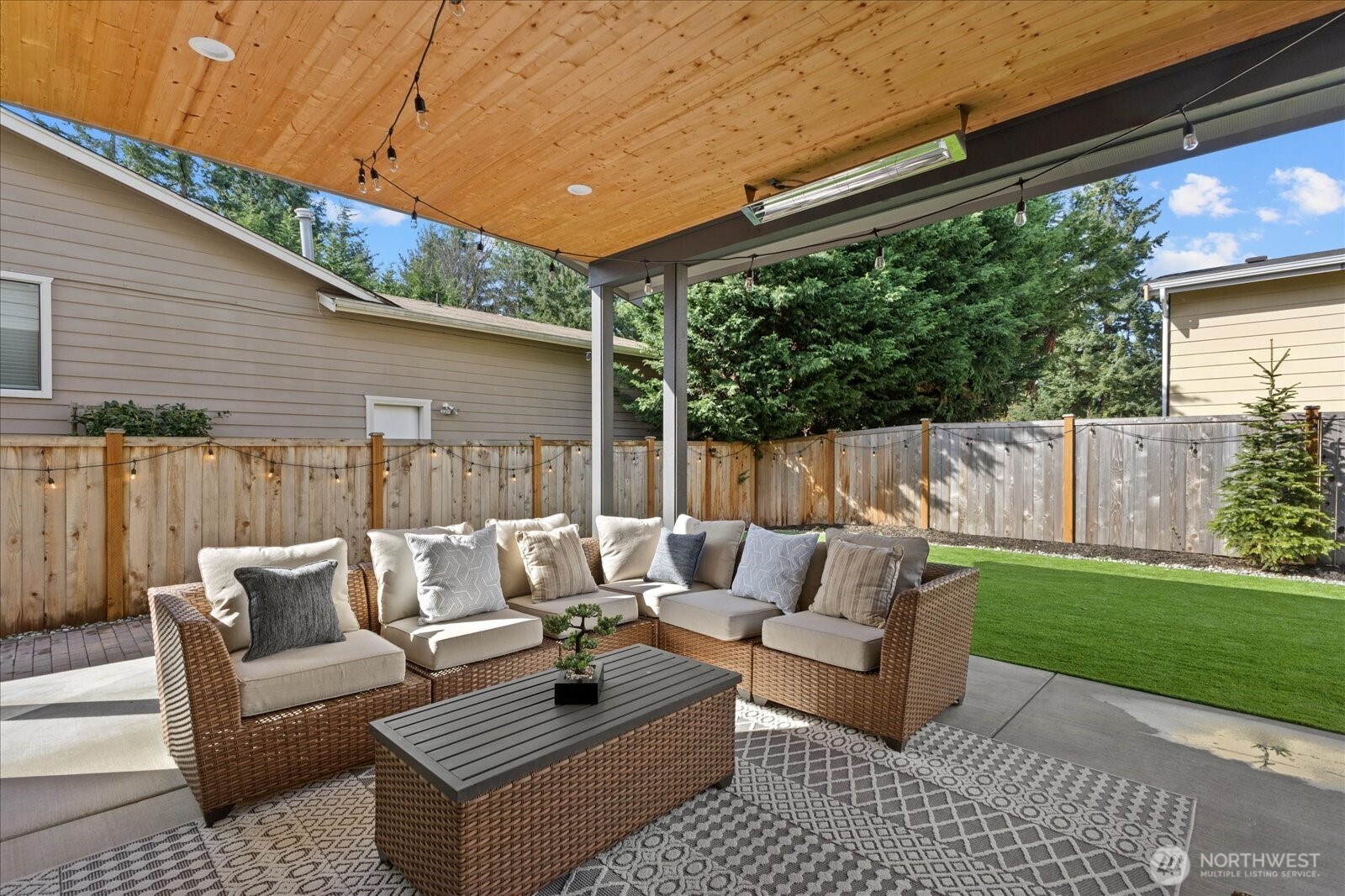The covered patio extends the living experience outdoors, opening to a beautifully maintained backyard with premium turf for effortless entertaining and low-maintenance luxury.