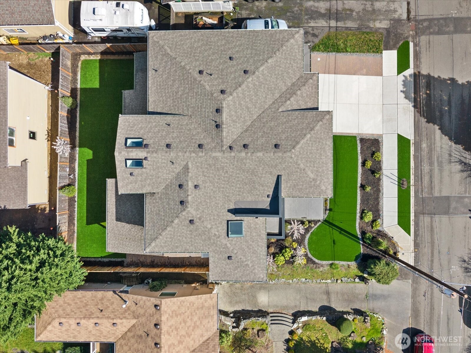 The aerial view reveals the full intention of the property—expansive footprint, beautifully curated outdoor spaces, and premium turf designed for polished, low-maintenance living.