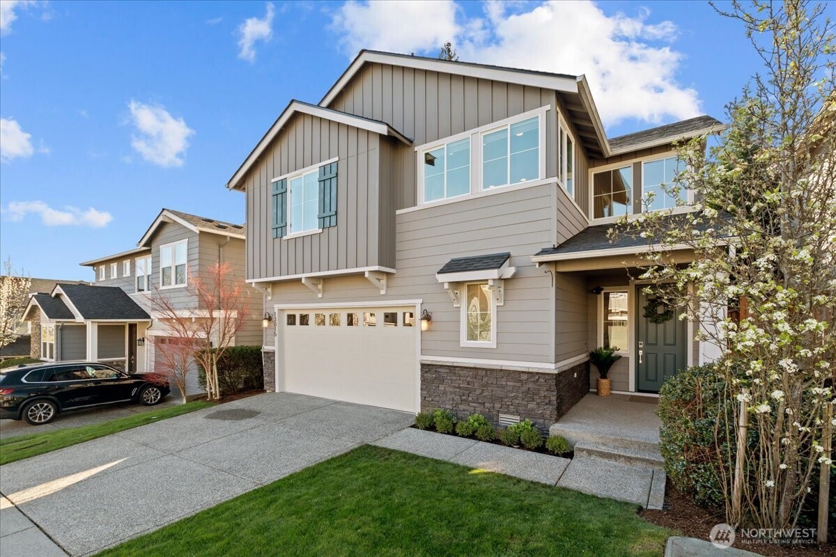 The craftsman style exterior features stone accents, board and batton siding and even a covered front porch