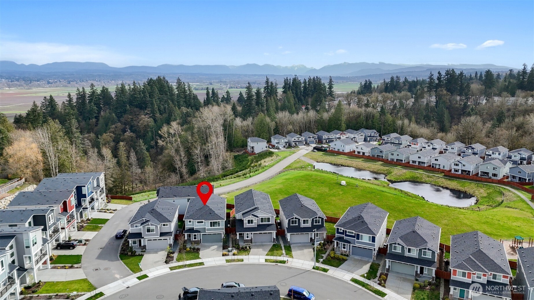 Distant aerial view highlighting the stunning mountain and valley vistas nearby.