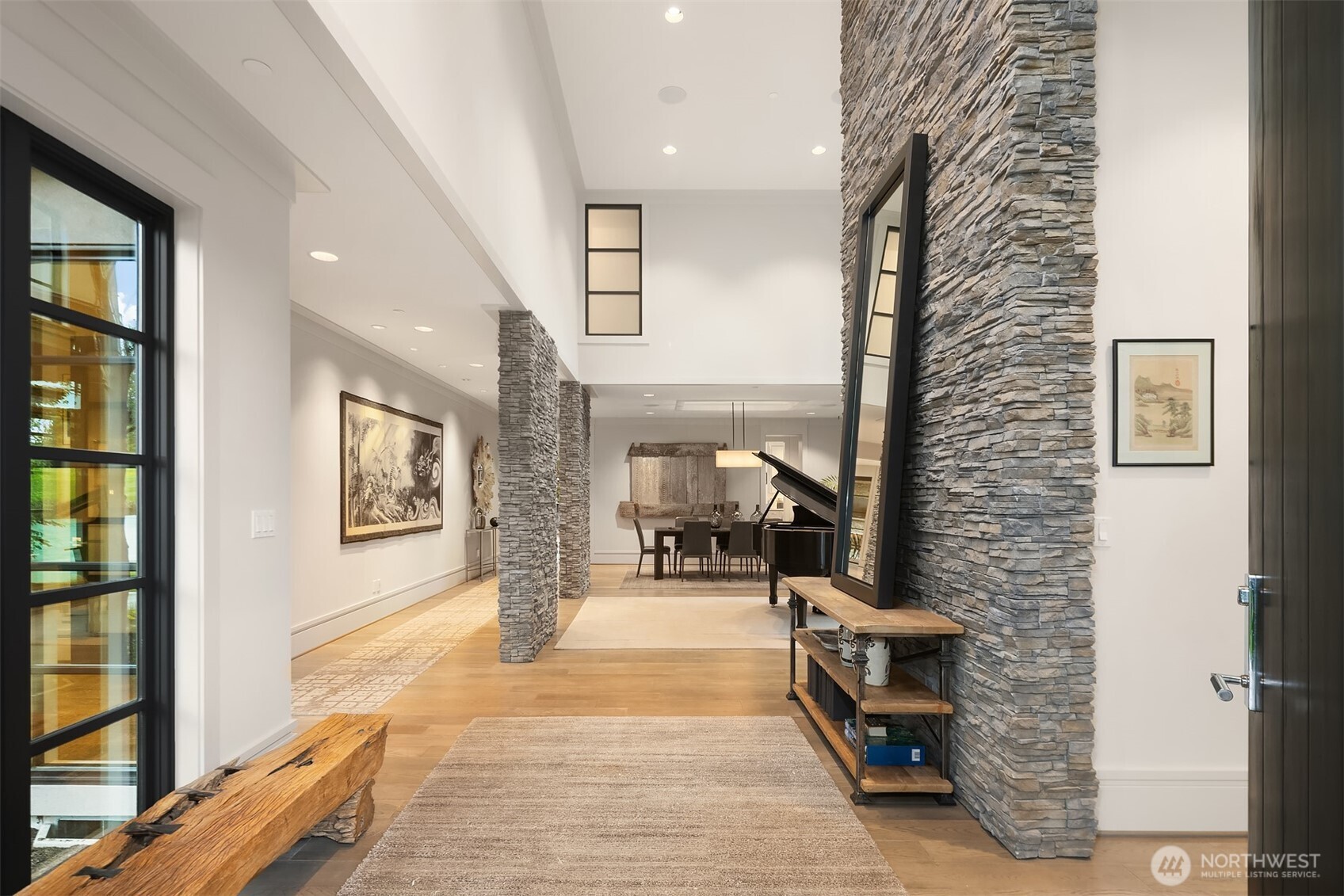 Stone and wood accents anchor the soaring 2-story entry.