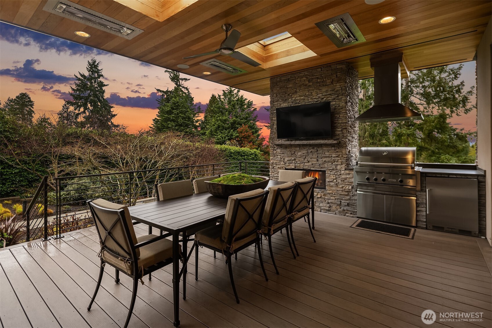 Year-long al fresco enjoyment awaits on the covered patio with Wolf grilling station, fireplace, overhead heaters, and mounted flat screen.