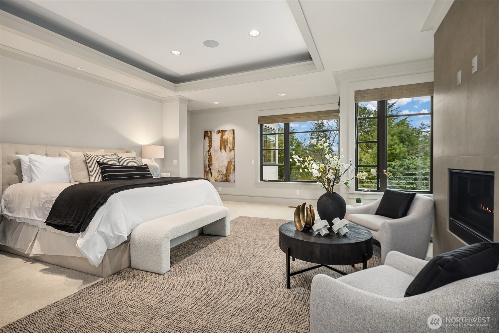 Your primary suite offers a romantic fireplace and private deck overlooking glimpses of Lake Washington.