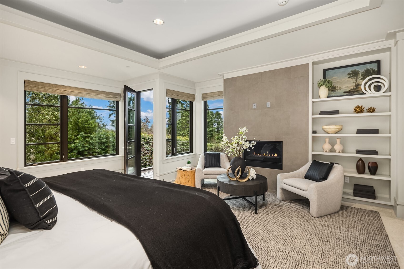 Custom shelving, fresh carpeting, and an inset ceiling with built-in speakers all elevate the space.