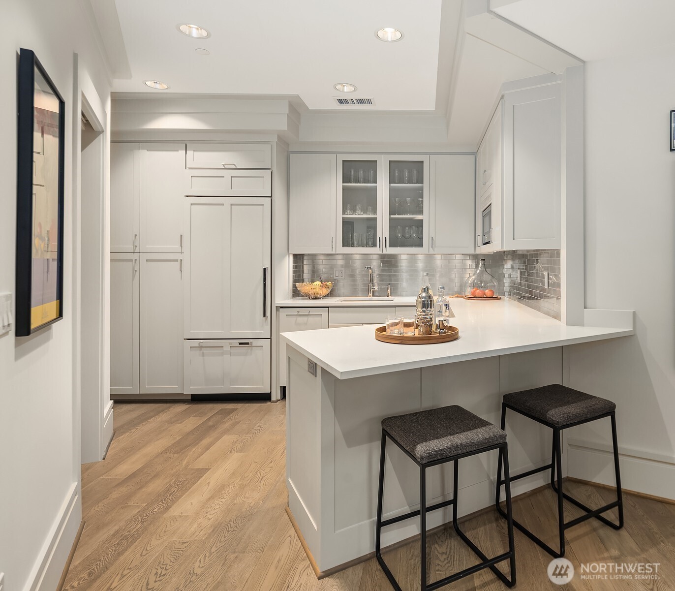 A kitchen just off the rec room offers a built-in SubZero, Bosch dishwasher, microwave, and ample storage.