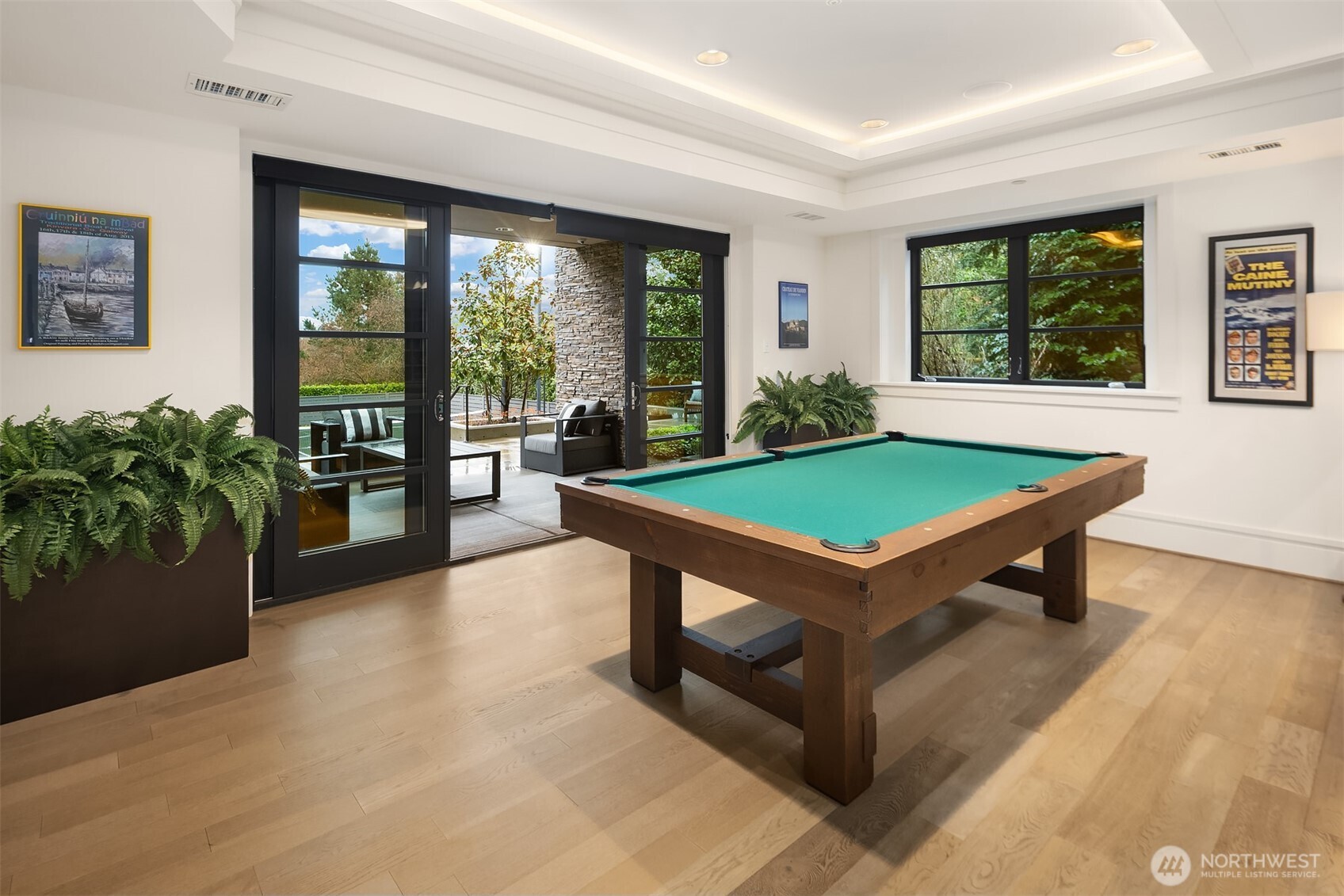 Double sliding doors open to the backyard entertaining areas and sport court.