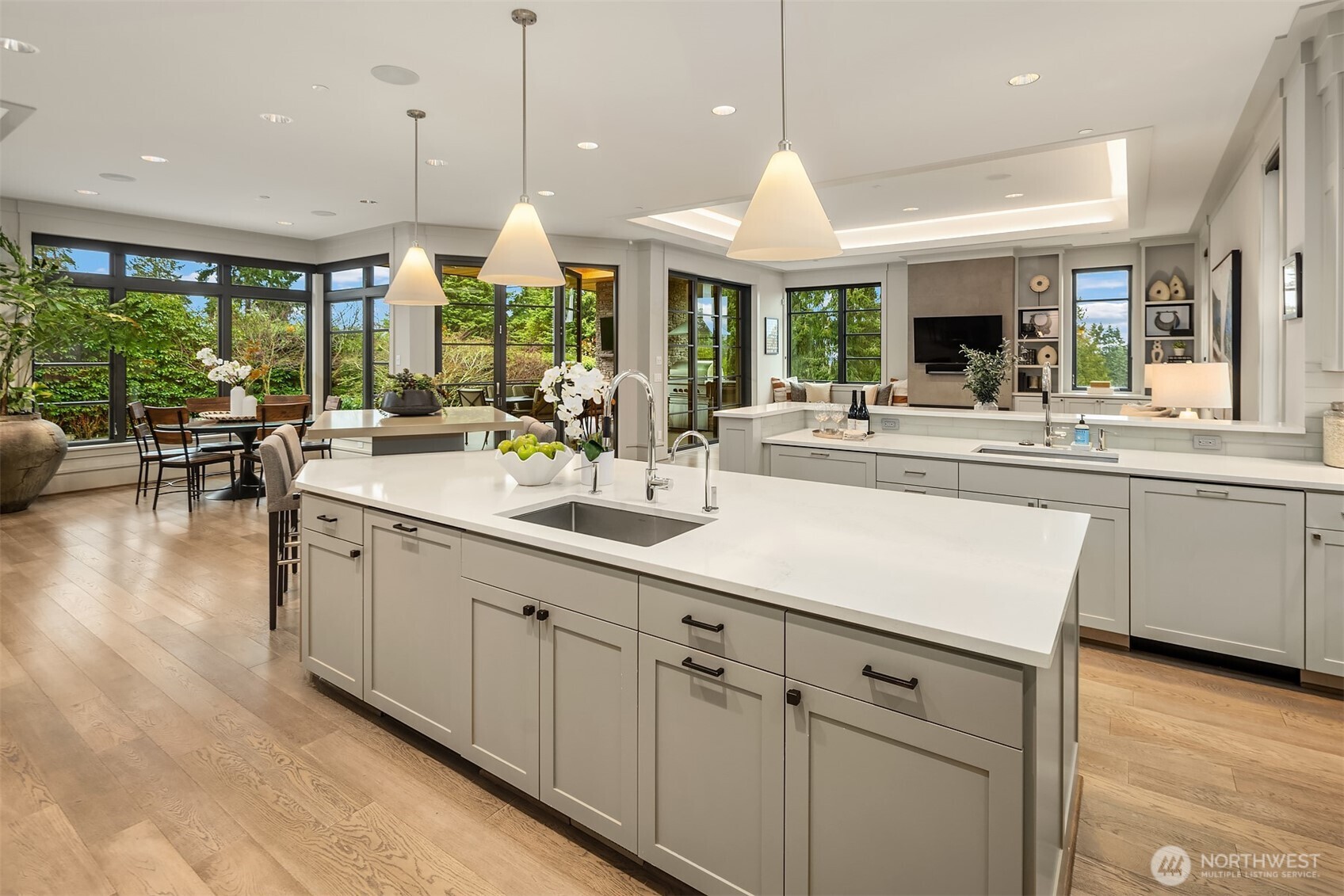 The informal great room forms a natural gathering hub centered around a center-stage kitchen.