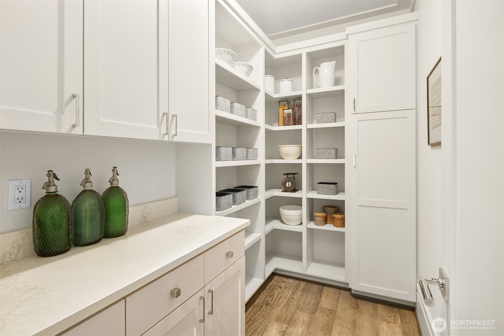 An additional walk-in pantry offers custom cabinetry and shelving.