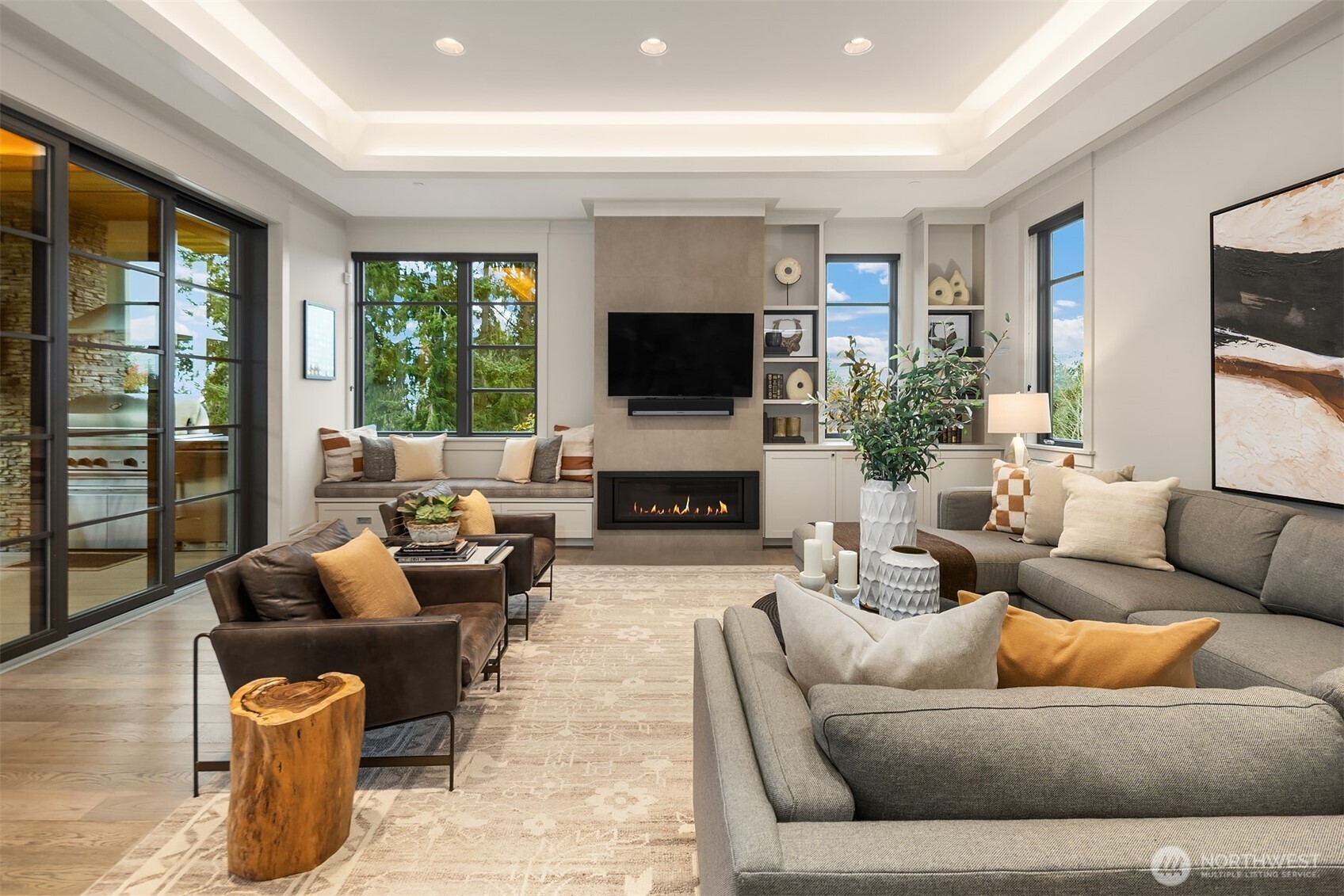 The family room is an invitation to relax with its cozy fireplace flanked by a window seat and custom built-ins.