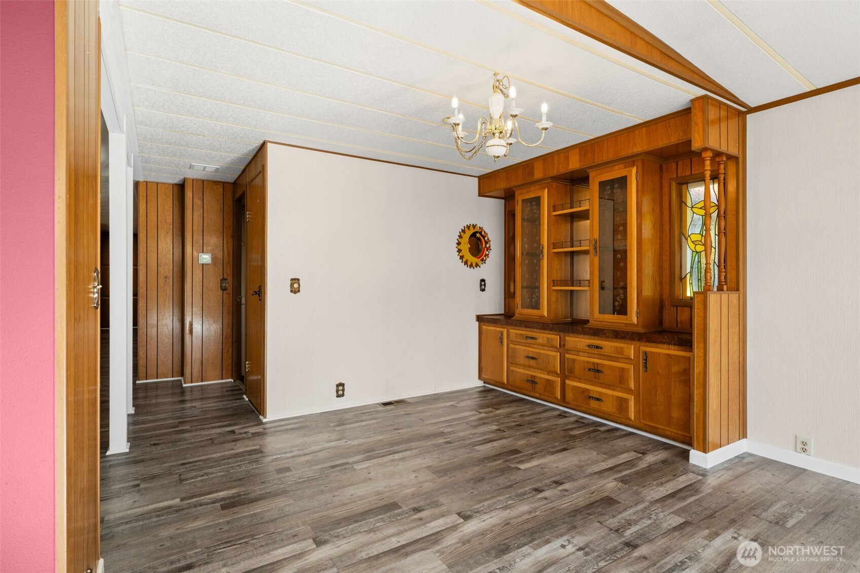 Dining space with lovely built in and darling stain glass.