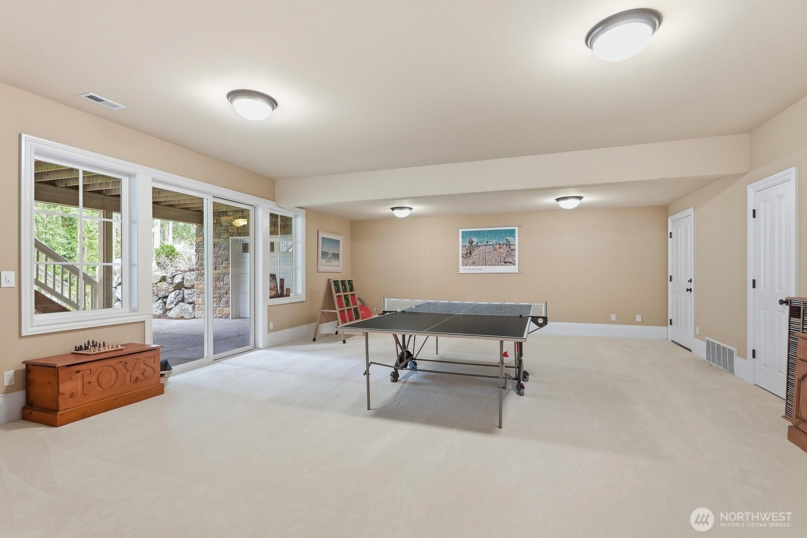 Huge rec room with sliding doors to the patio and yard. A door here leads to the 1500 sq ft unfinished space.