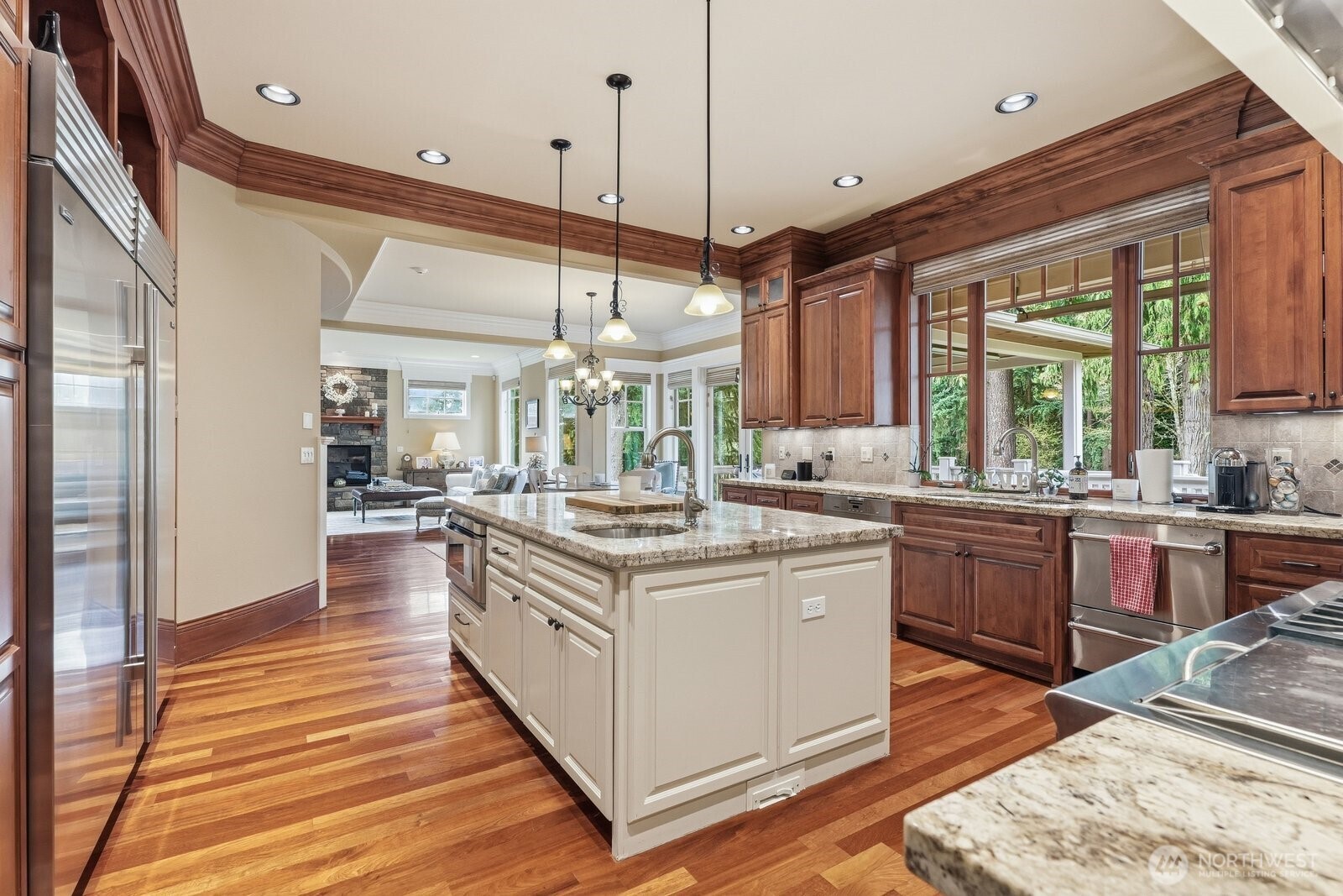 Center island with drawer microwave and 60-inch Subzero refrigerator/freezer.