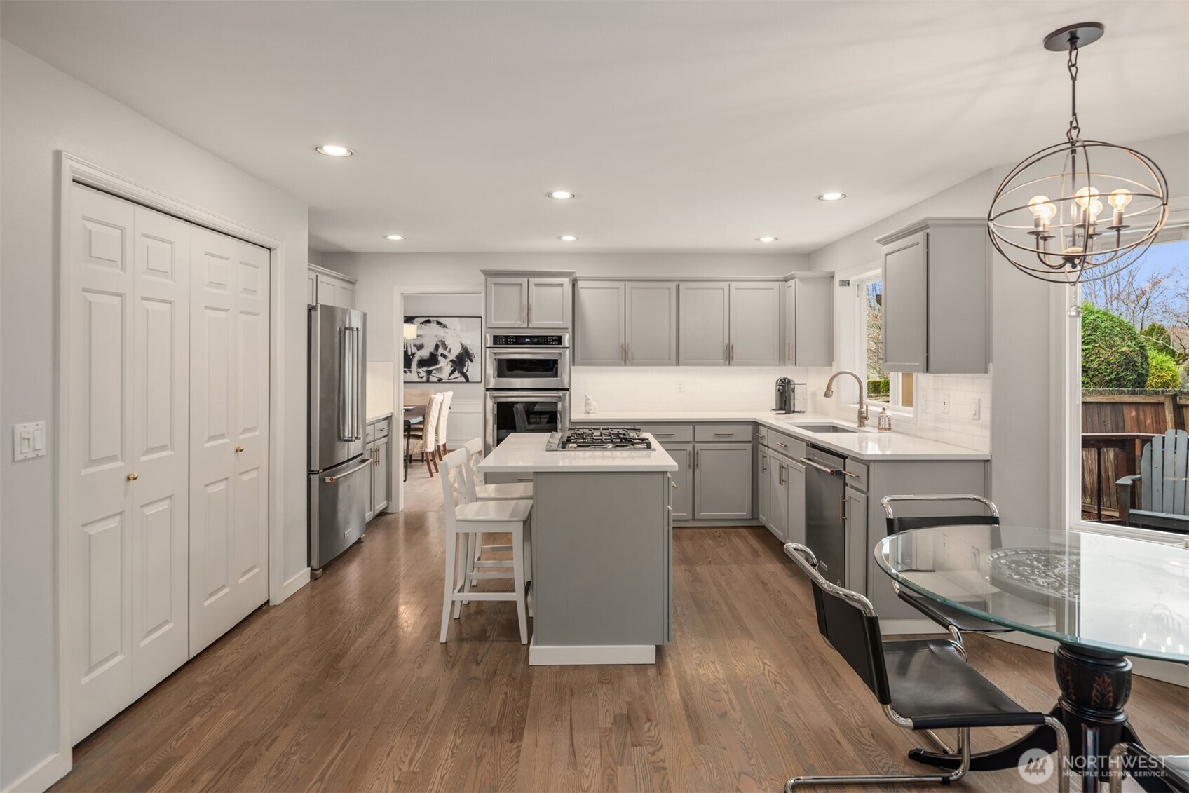Kitchen features armoire fridge and pantry.