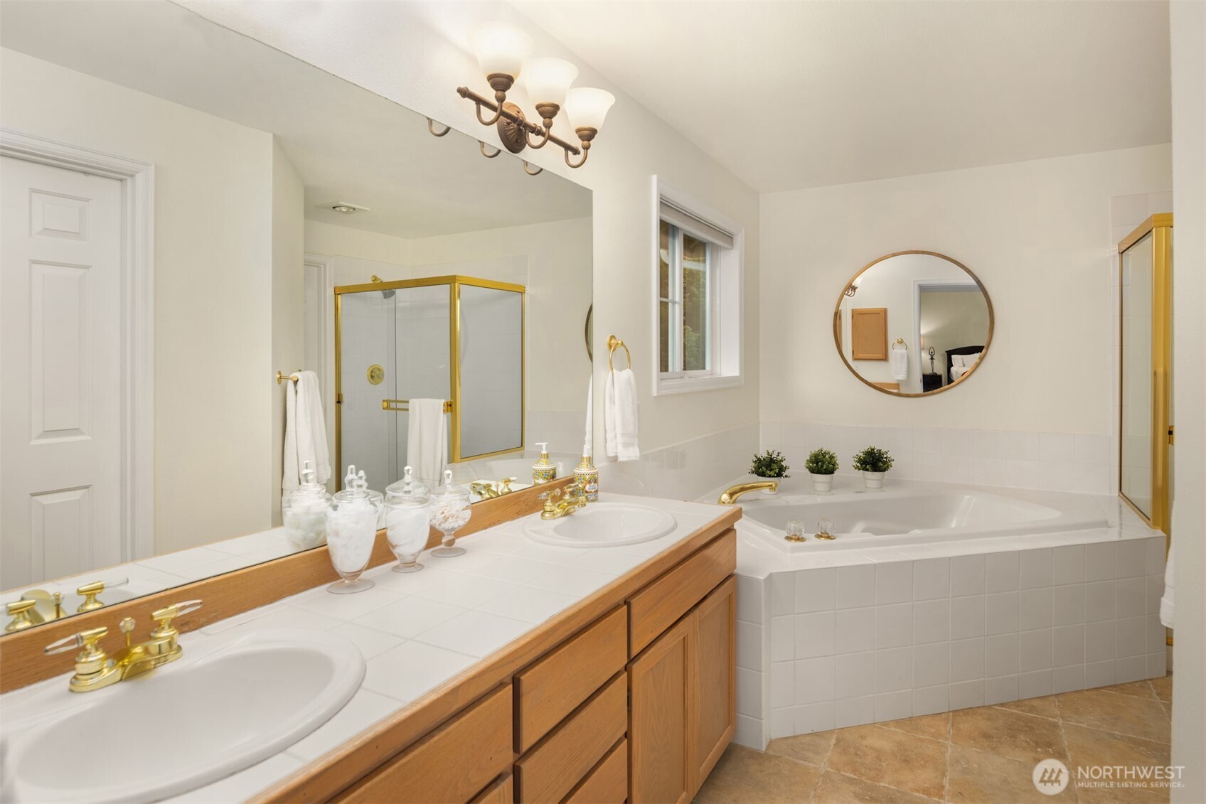 Primary bath features heated tile flooring, dual vanities, soaking tub and separate shower.