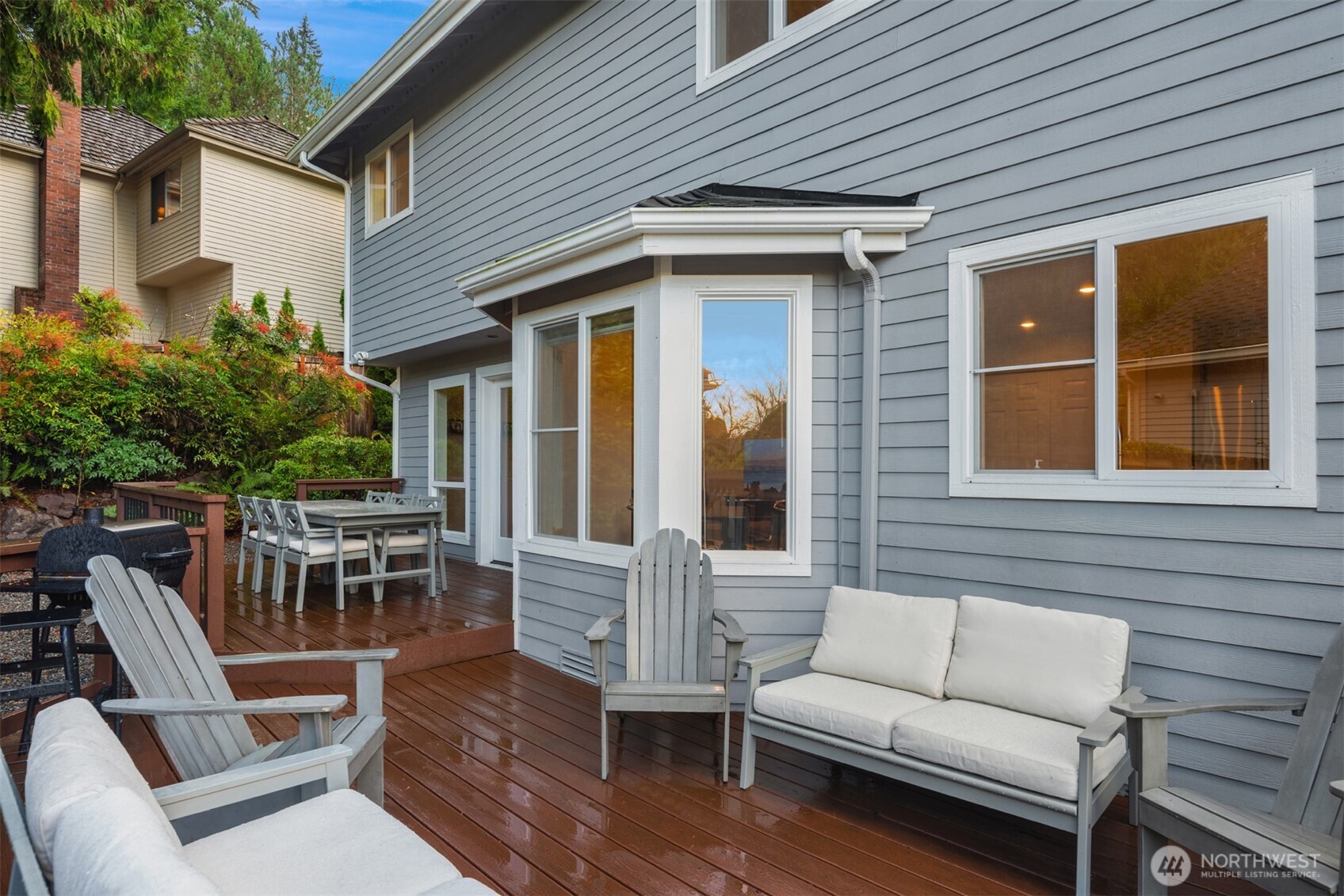 Outdoor Living Room Toward Dining on Multi-level Deck Shows Bay Window from Exterior