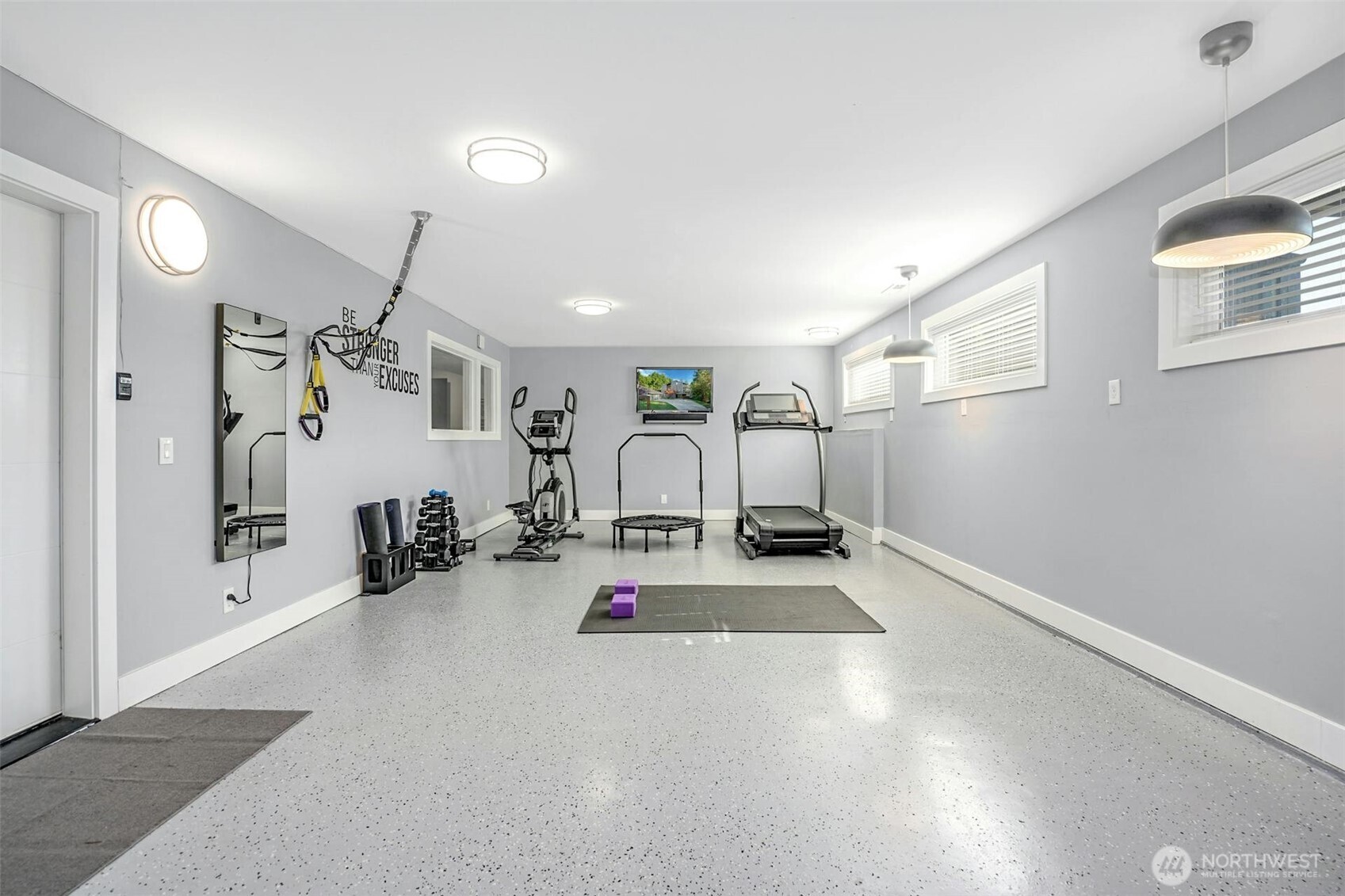 Attached heated flex space with epoxy floor currently housing in-home gym but can accommodate 2-cars tandem for a collector car showcase or ???