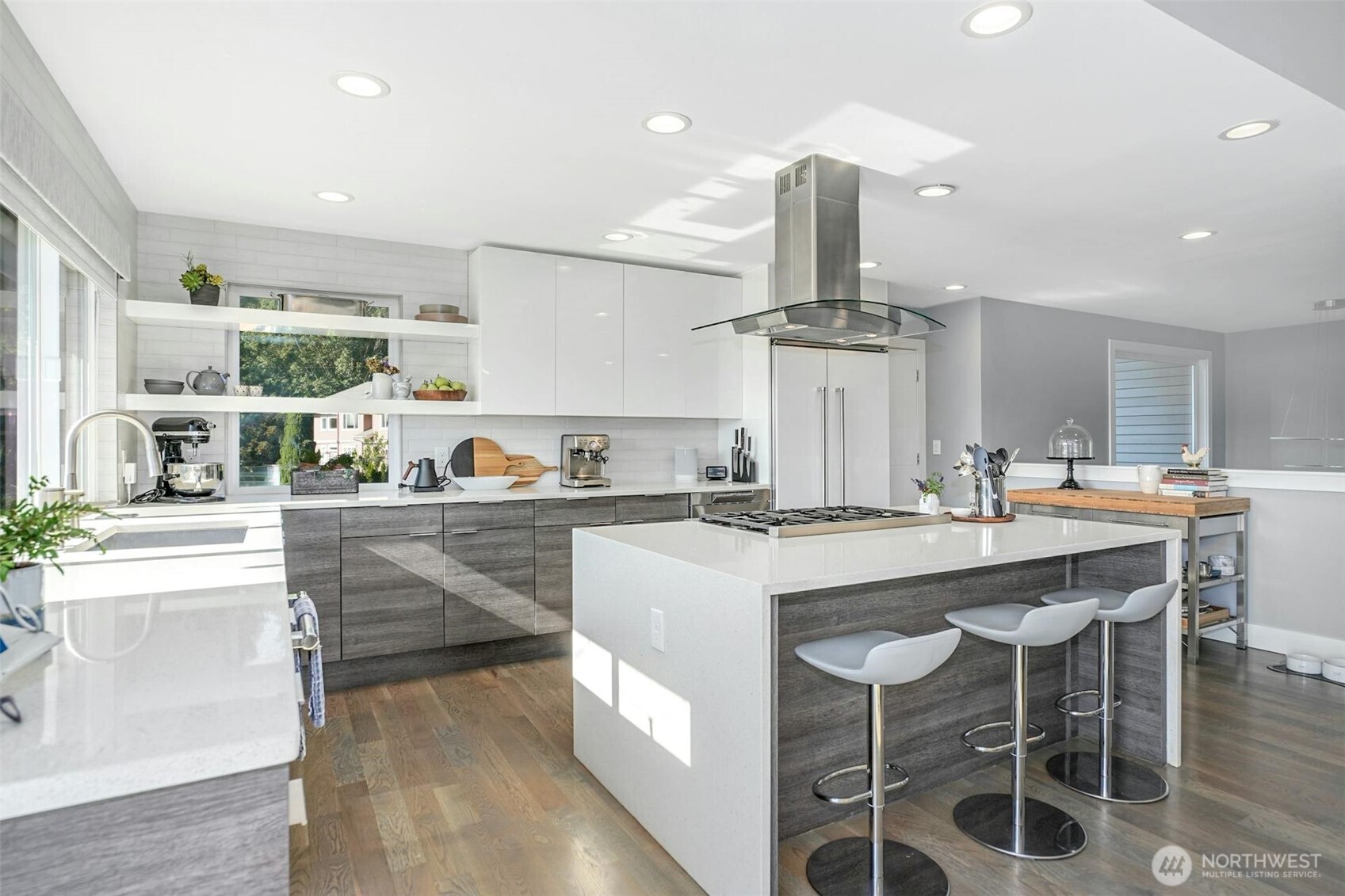 Chef’s kitchen comes complete with a new Thermador range, dishwasher, waterfall island, and custom walk-in pantry