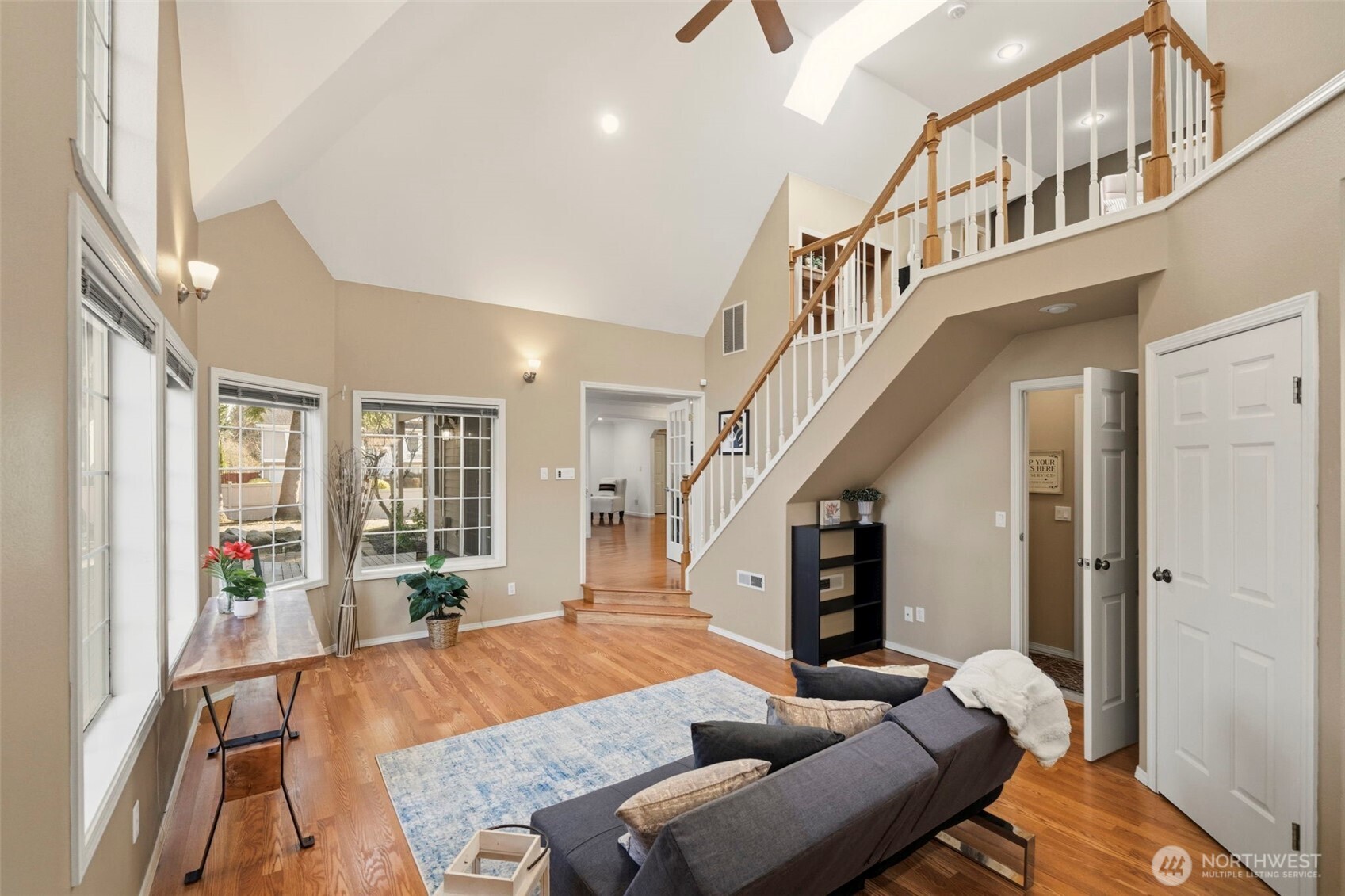 French doors open to a versatile secondary living area that can serve as a quiet retreat, media room, or extended living space.