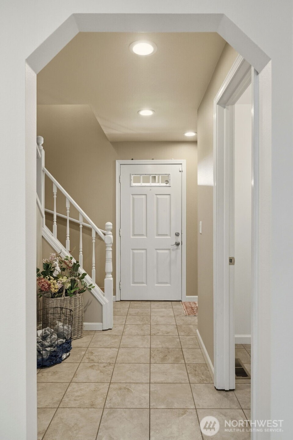 Just off the entry, a convenient powder room adds functionality for guests and everyday living.