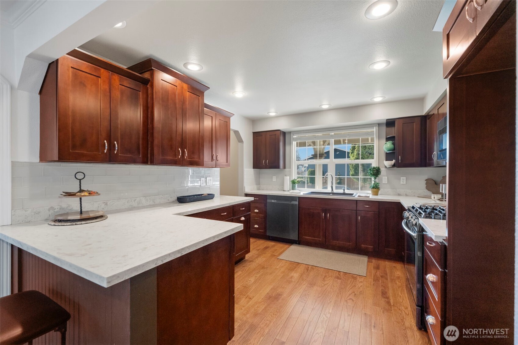 This updated kitchen offers beautiful quartz countertops, natural light, and an easy flow to the dining and living spaces, ideal for everyday living.