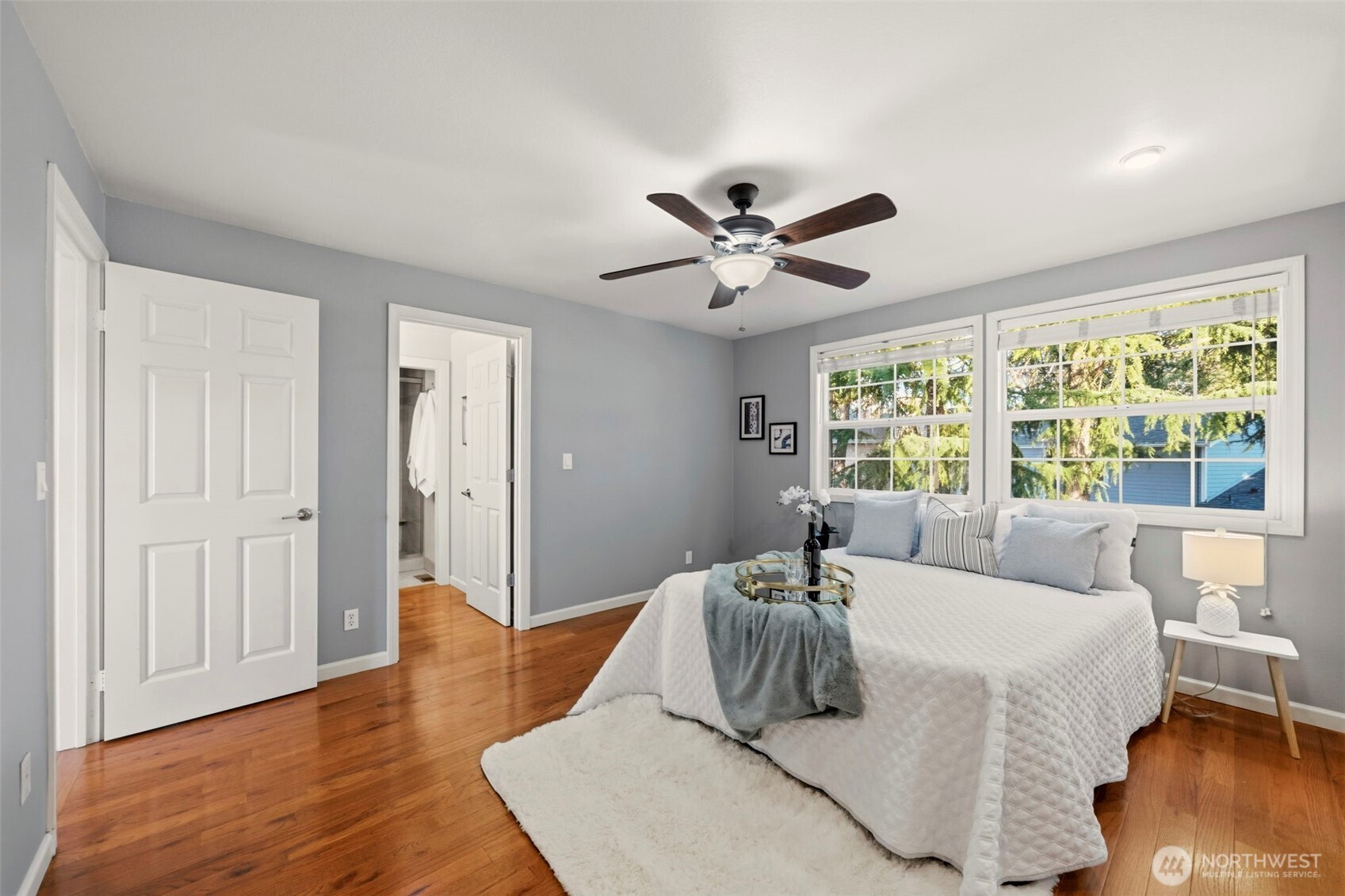 Principal bedroom showing generous floor space, natural light, and access to the en-suite bath.