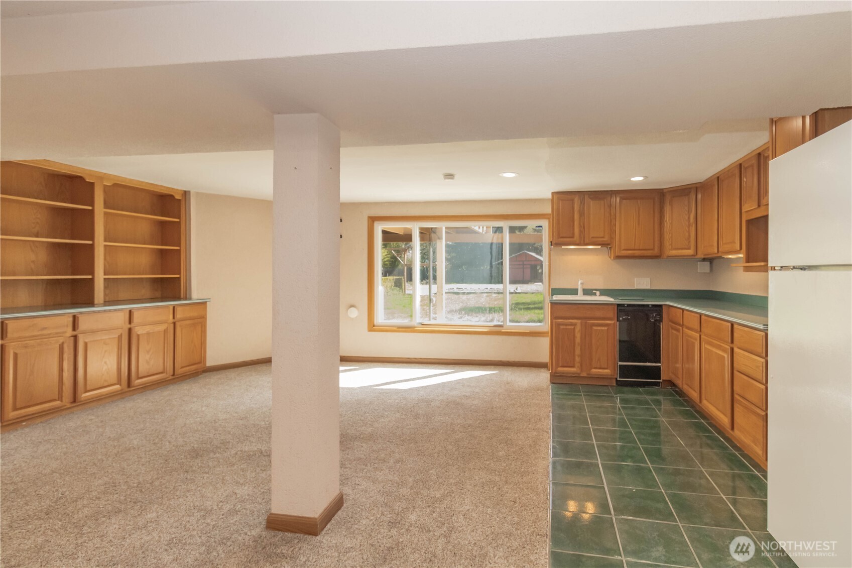 Another view of the huge built-ins to left and kitchen cabinetry